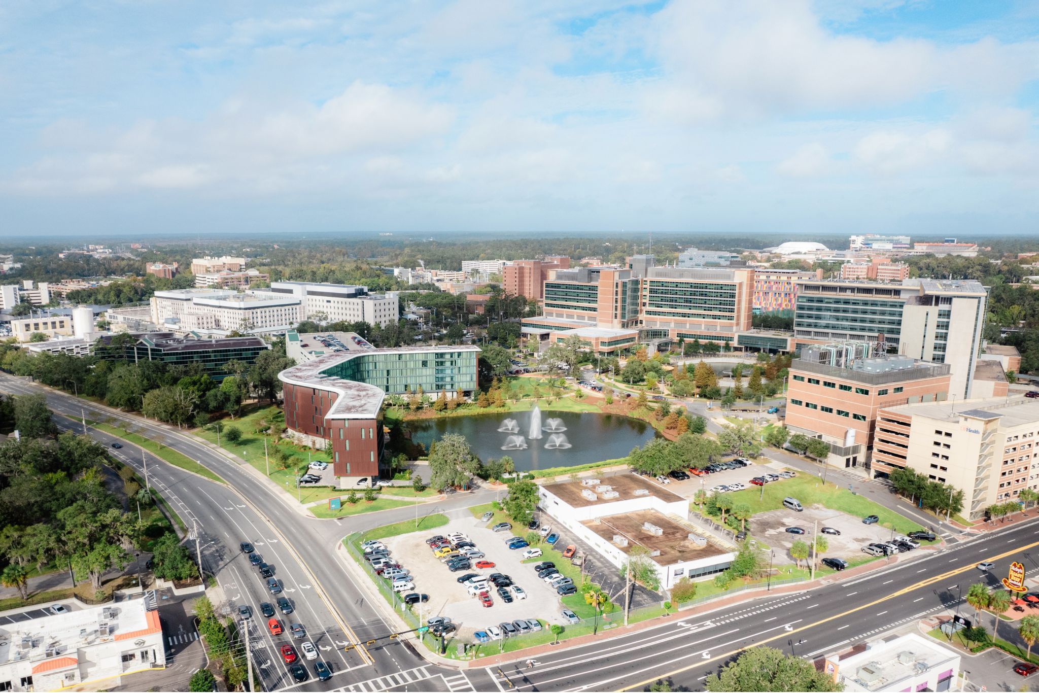 image An aerial view showcases the modern architecture of Hotel ELEO amidst the vibrant landscape of the University of Florida campus.