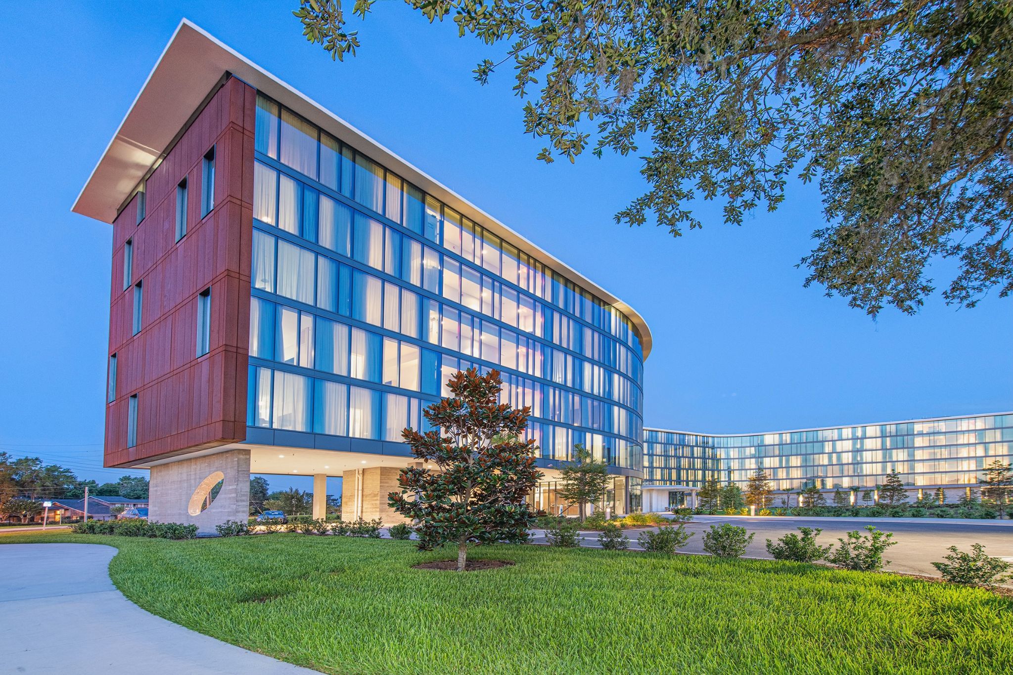 image The distinctive facades of Hotel ELEO blend contemporary architecture with organic elements, showcasing a stunning contrast against the twilight sky.