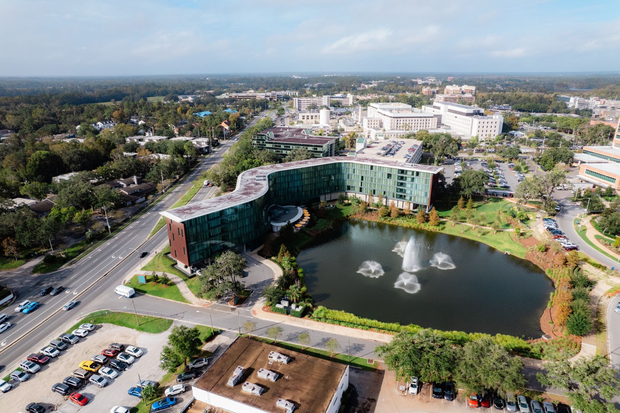 image Offering a bird’s-eye view, this elegant hotel showcases its sleek design with expansive glass panels that reflect the beauty of its surroundings.