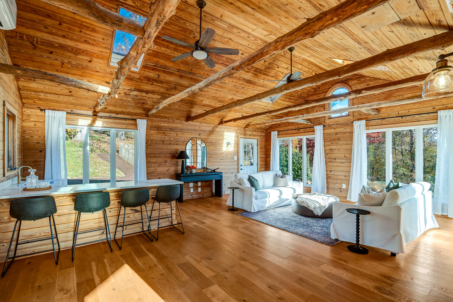 image With vaulted wood-beam ceilings, plush sofas, and forest views, the Wood Room is truly ideal for peaceful relaxation.