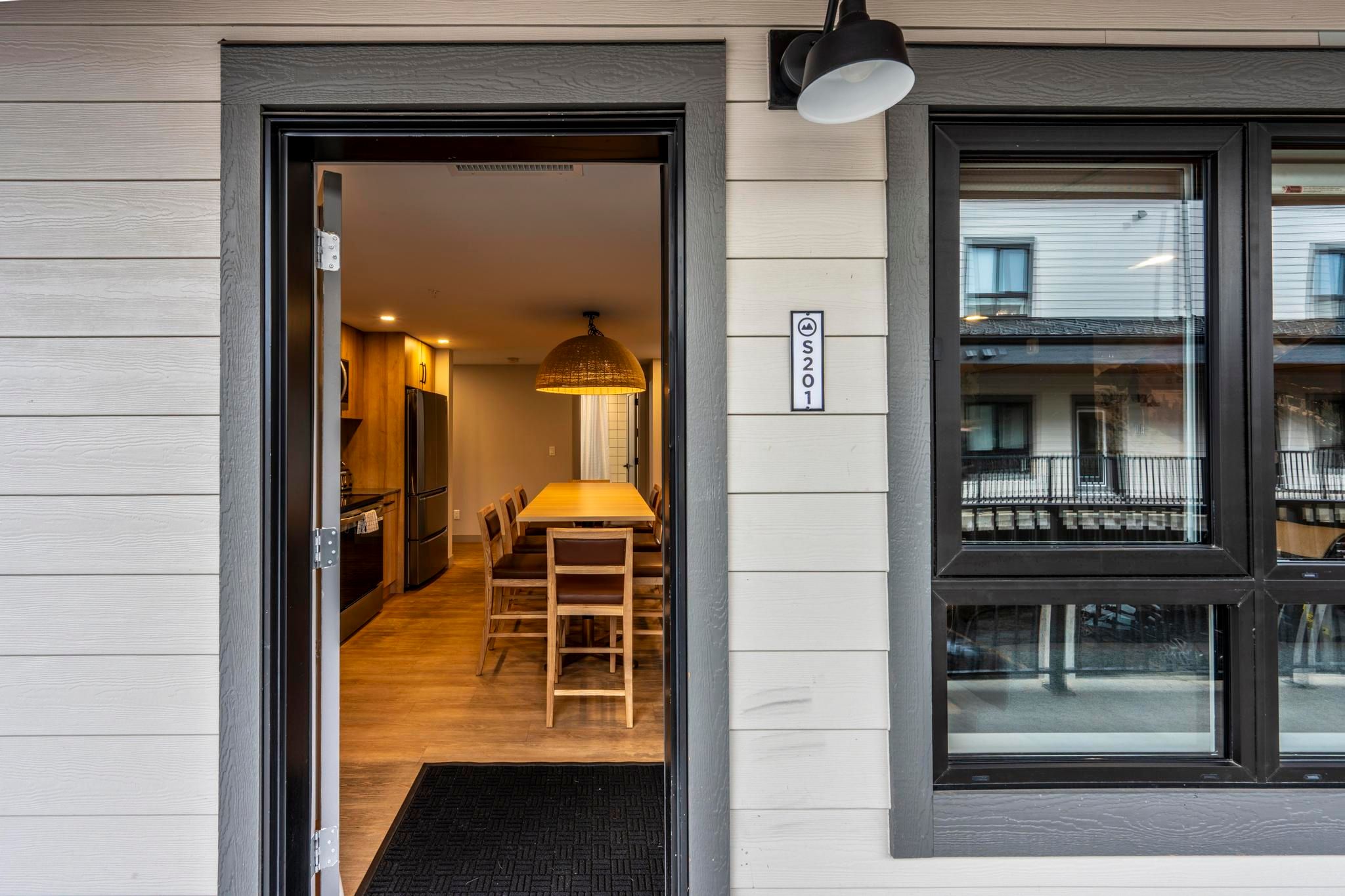 image Stepping through the front door of S201 reveals an inviting open layout that seamlessly blends comfort and modernity, capturing the essence of cozy living in the heart of downtown Revelstoke.