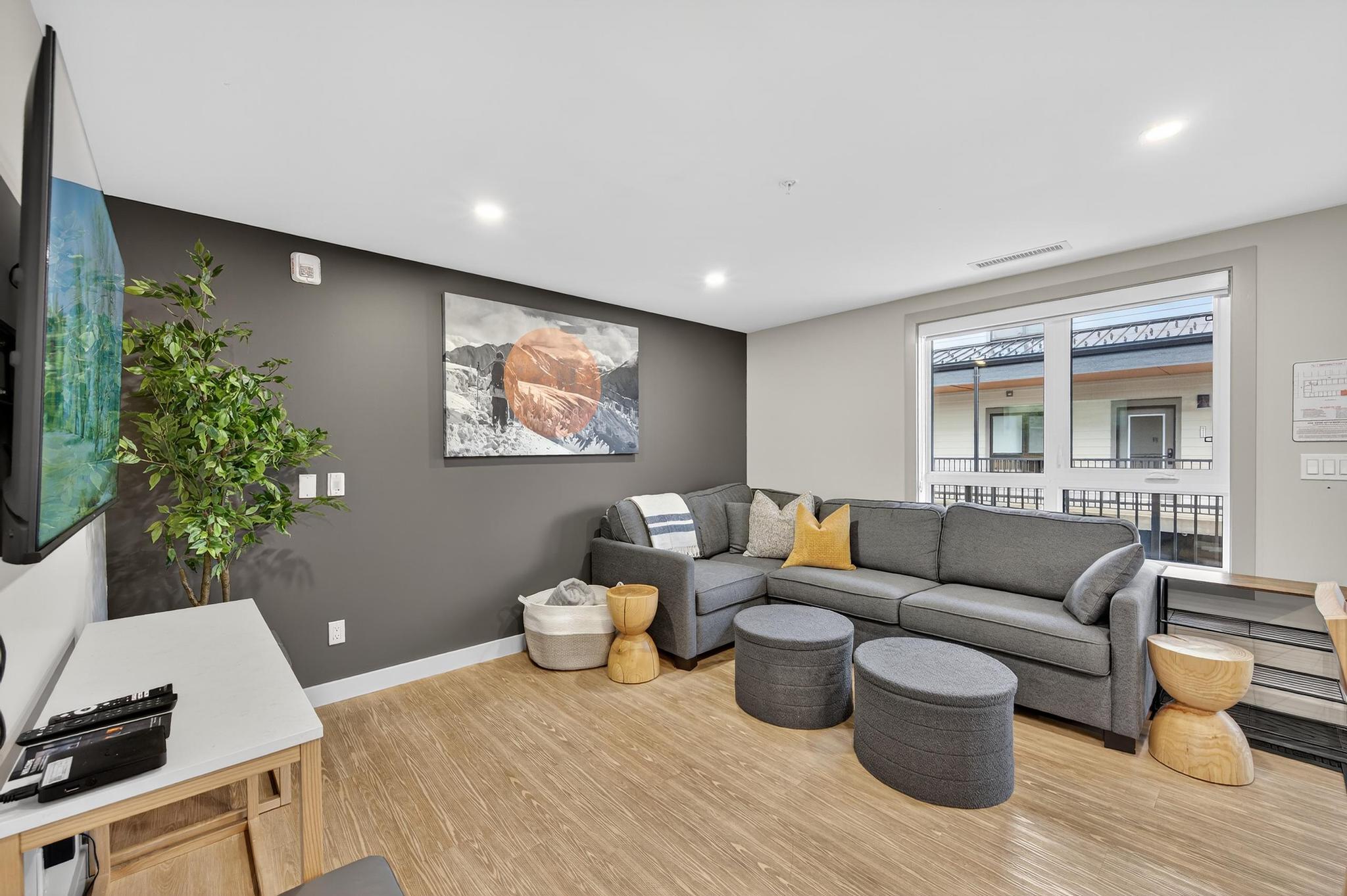 image Inside, the cozy living area invites relaxation with its soft seating and warm earthy tones, complementing the breathtaking mountain views just outside the large windows.