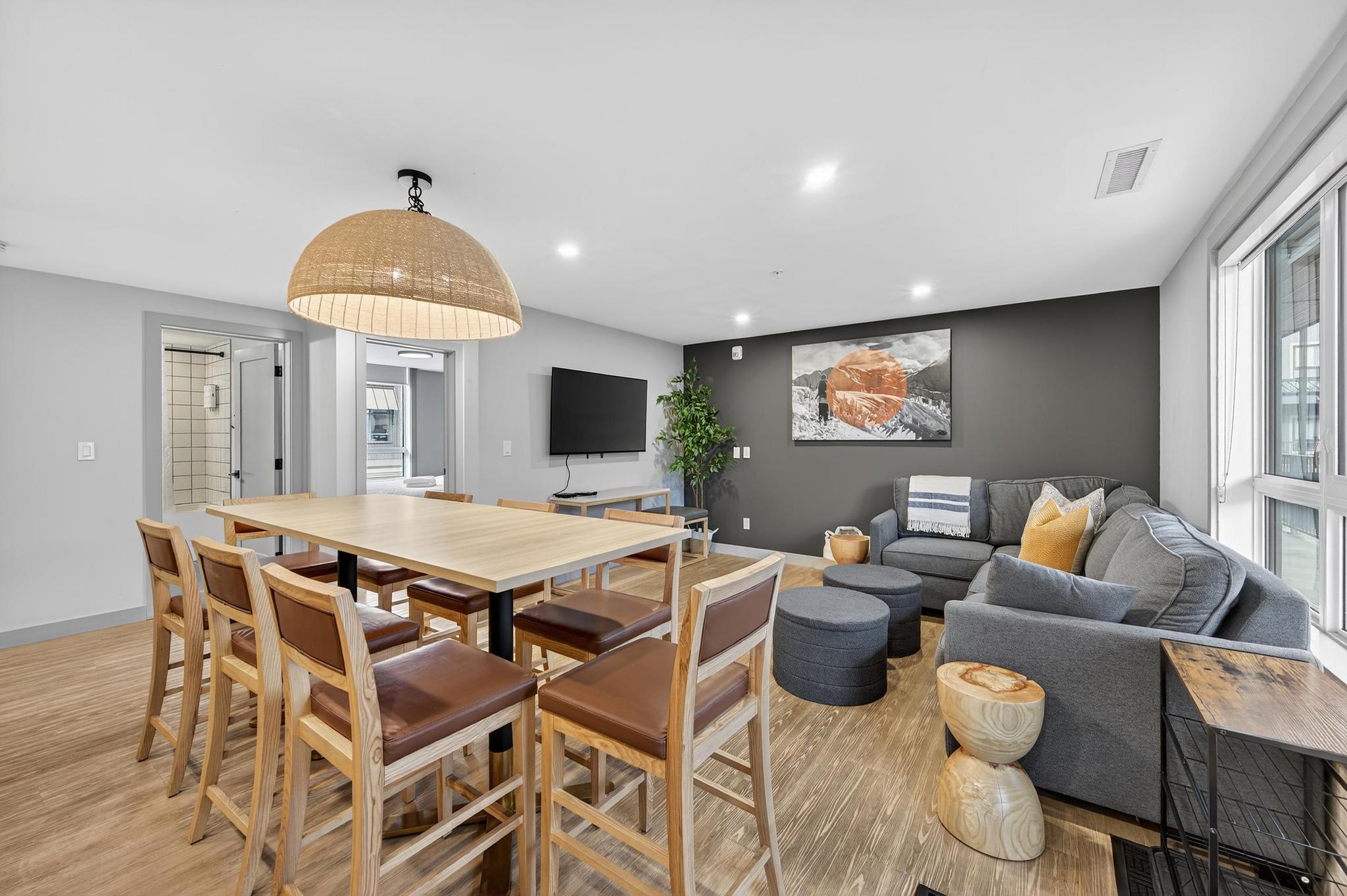 image The inviting dining area boasts a large wooden table and contemporary lighting, creating a warm space perfect for family gatherings or relaxing evenings after a day of outdoor adventures.