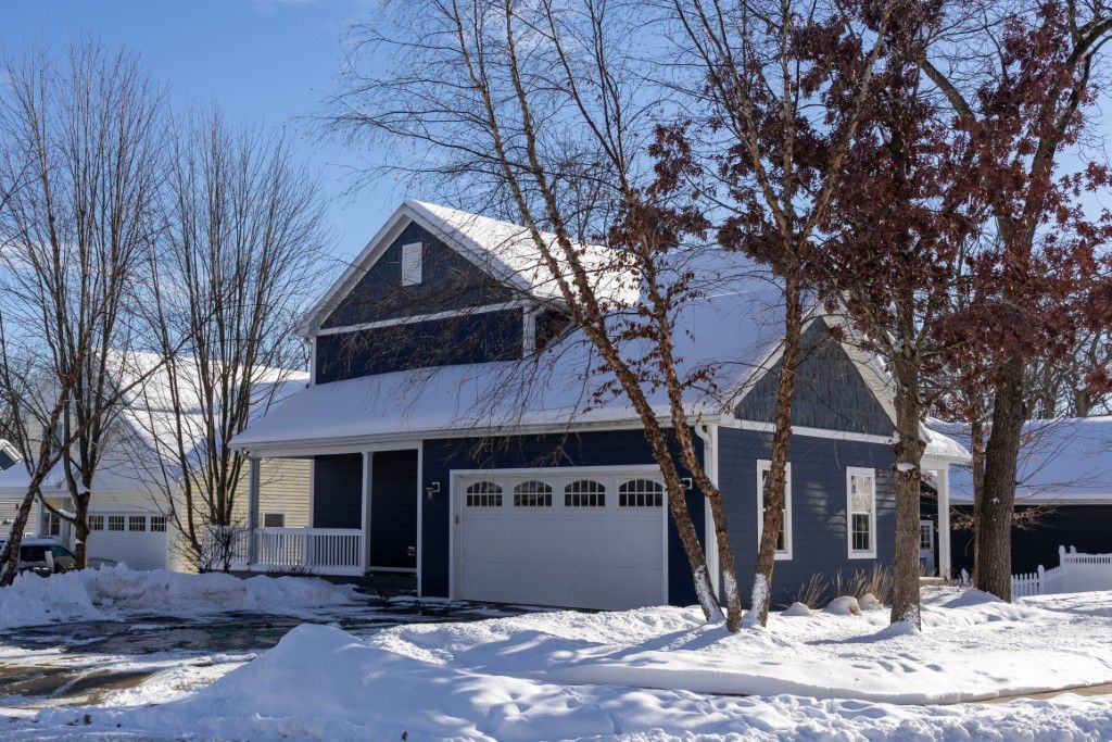 image Nestled in a winter wonderland, this charming blue house at 895 Platt Ave beckons with its cozy, inviting facade, perfect for family gatherings and serene lake-side retreats.
