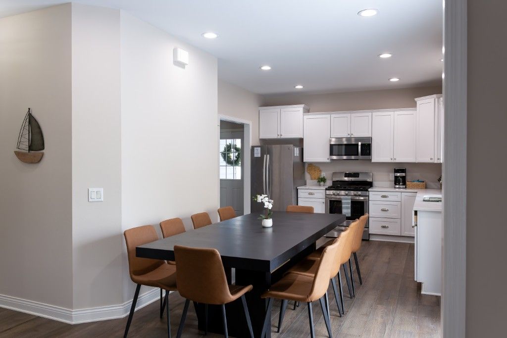 image The modern kitchen and dining area create a welcoming atmosphere for families to share meals and laughter, with ample seating that enhances the home-like feel of this delightful getaway.
