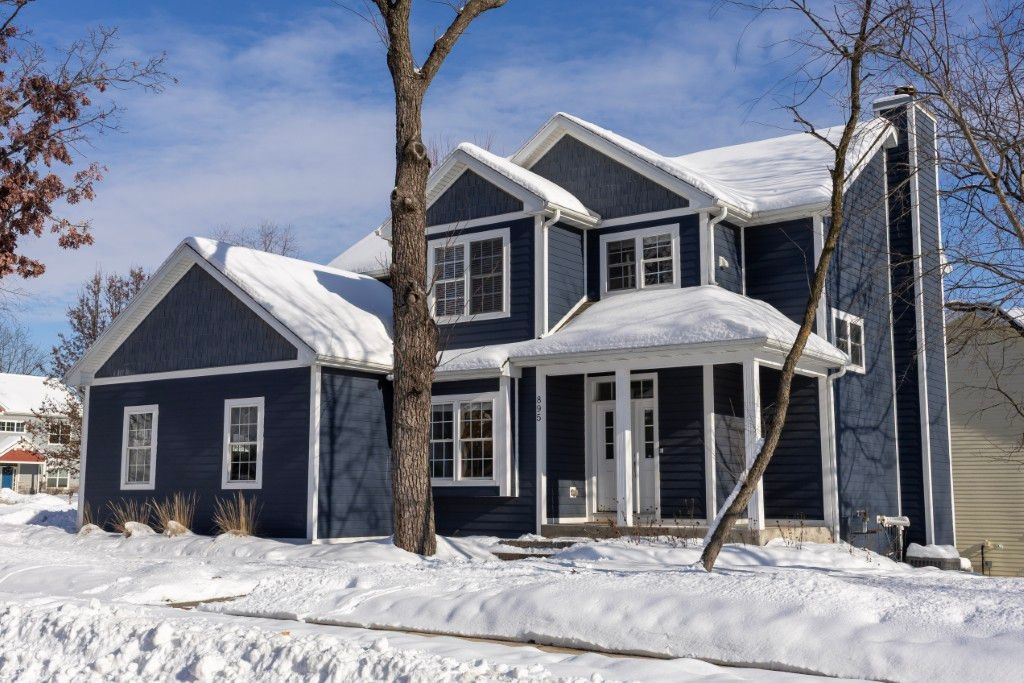 image This cozy home, framed by snow-kissed trees, exudes warmth and charm, creating an inviting haven for families to gather and create lasting memories in Lake Geneva.