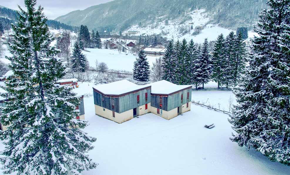 image A charming lodge sits peacefully in the winter wonderland of Lélex, surrounded by majestic mountains and fresh snowfall.