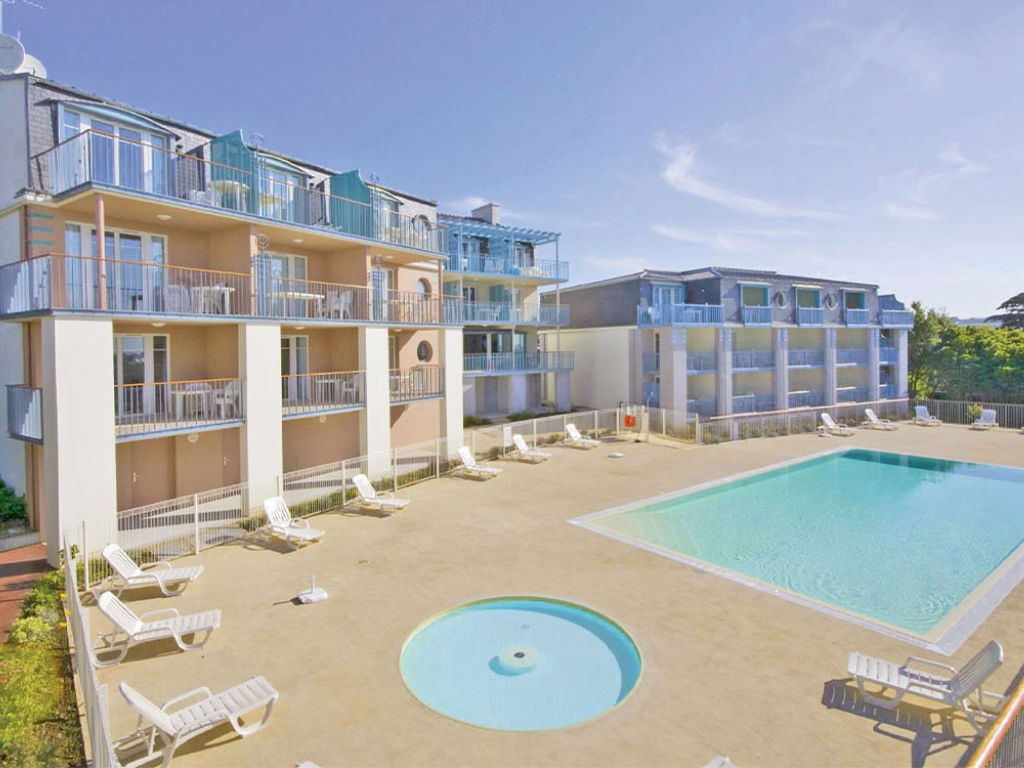 image Dive into relaxation by the sparkling pool, surrounded by inviting sun loungers.