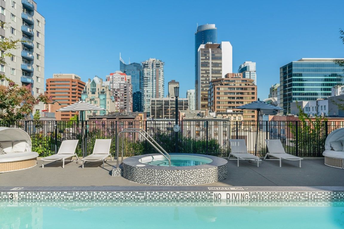 image Set against a striking city skyline, the rooftop pool area features a relaxing hot tub and lounge chairs, inviting guests to unwind in a vibrant atmosphere.