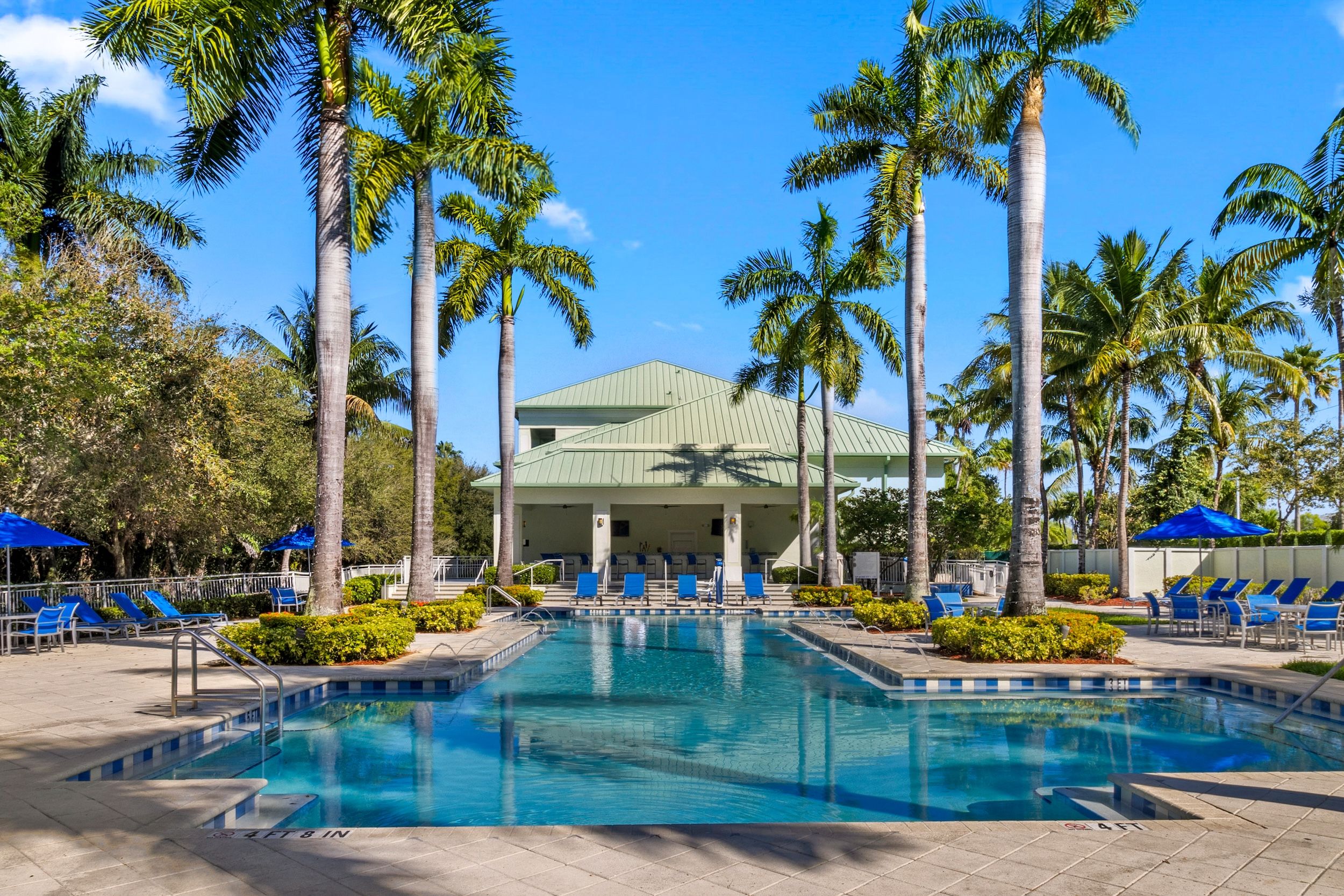 image Resort pool overlooking the clubhouse, featuring ample seating and a bright, open layout.