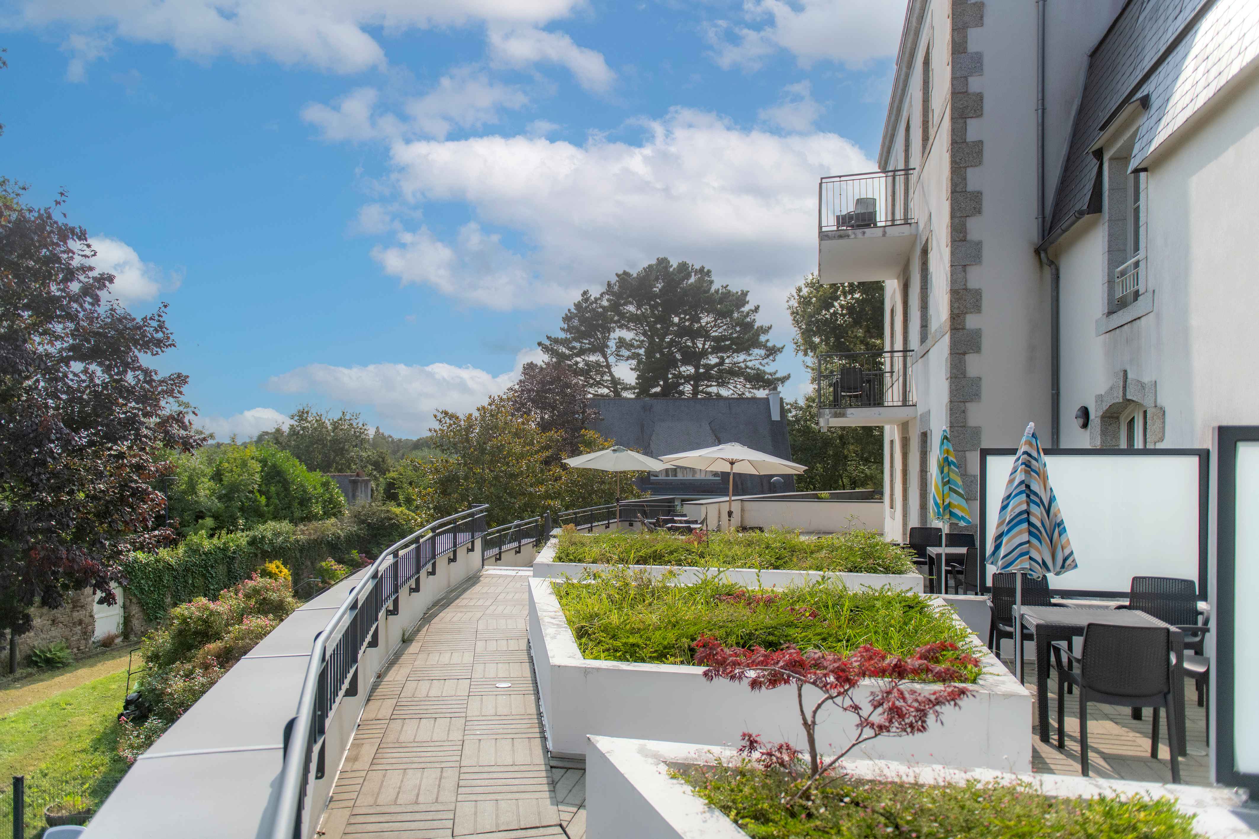 image Breakfast or an afternoon read — the shaded terrace overlooking the park gives you a quiet spot above the town.
