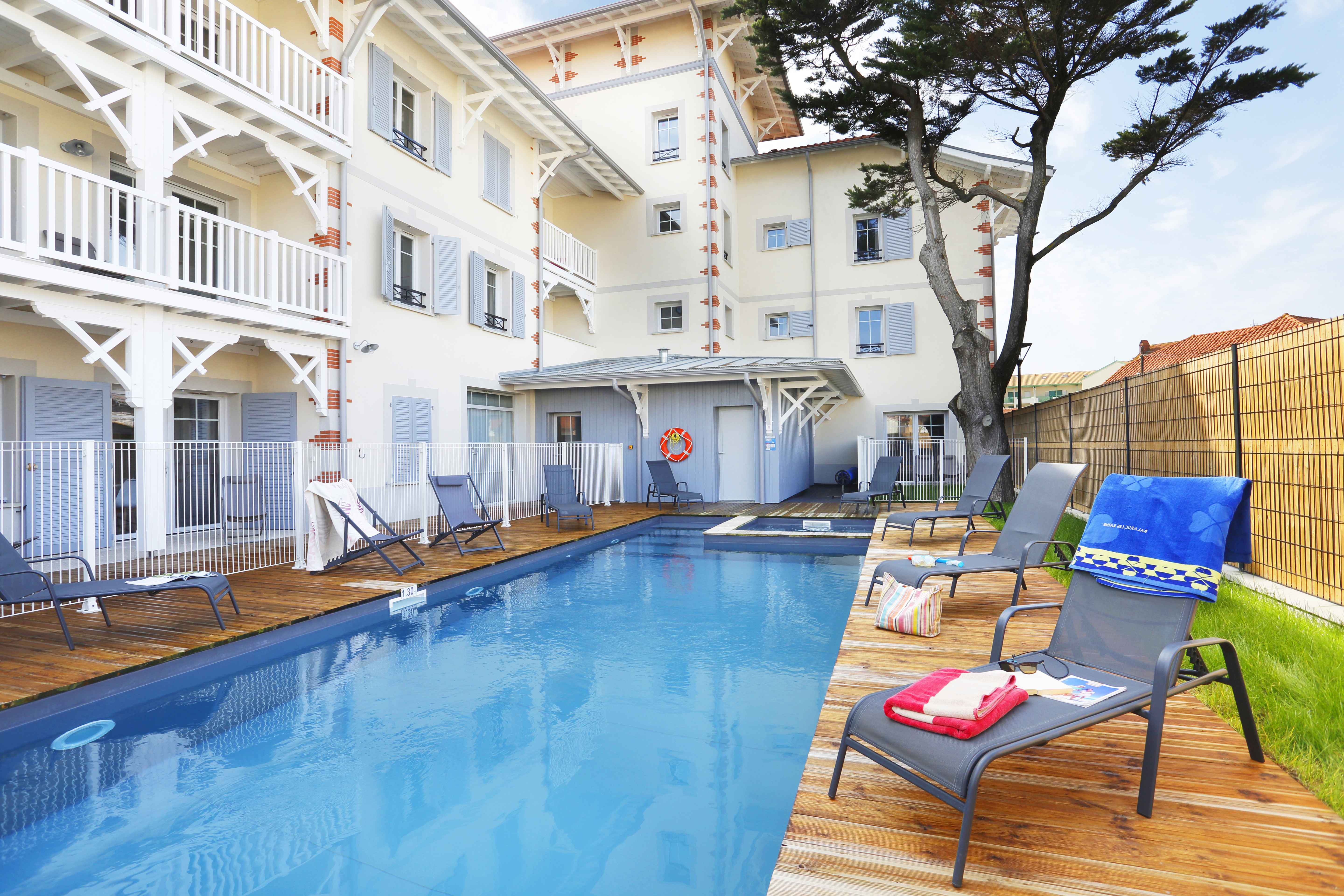 image Take a refreshing dip in the heated pool, surrounded by comfortable loungers and lush greenery.