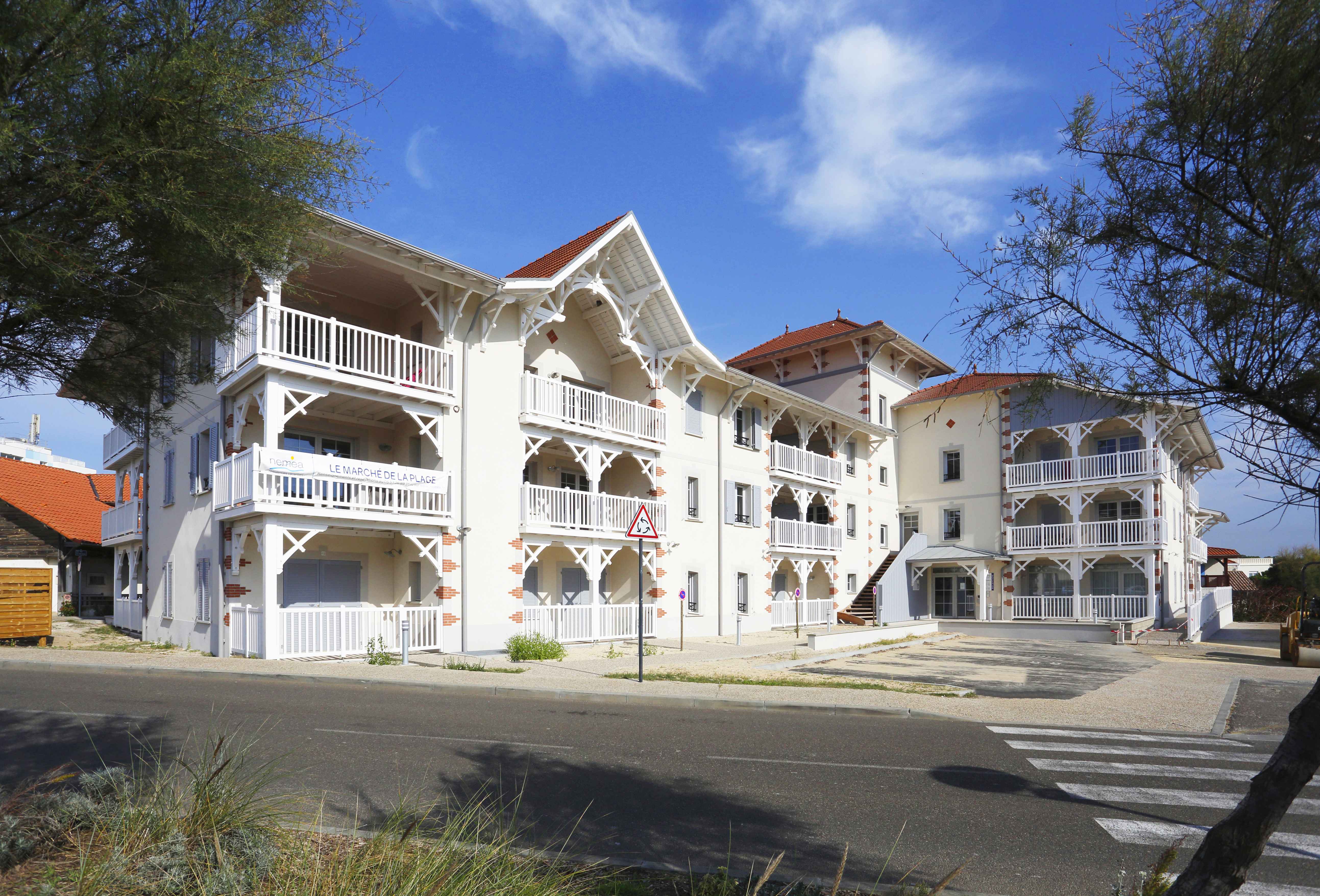 image Discover the allure of coastal living with inviting balconies and classic design elements.
