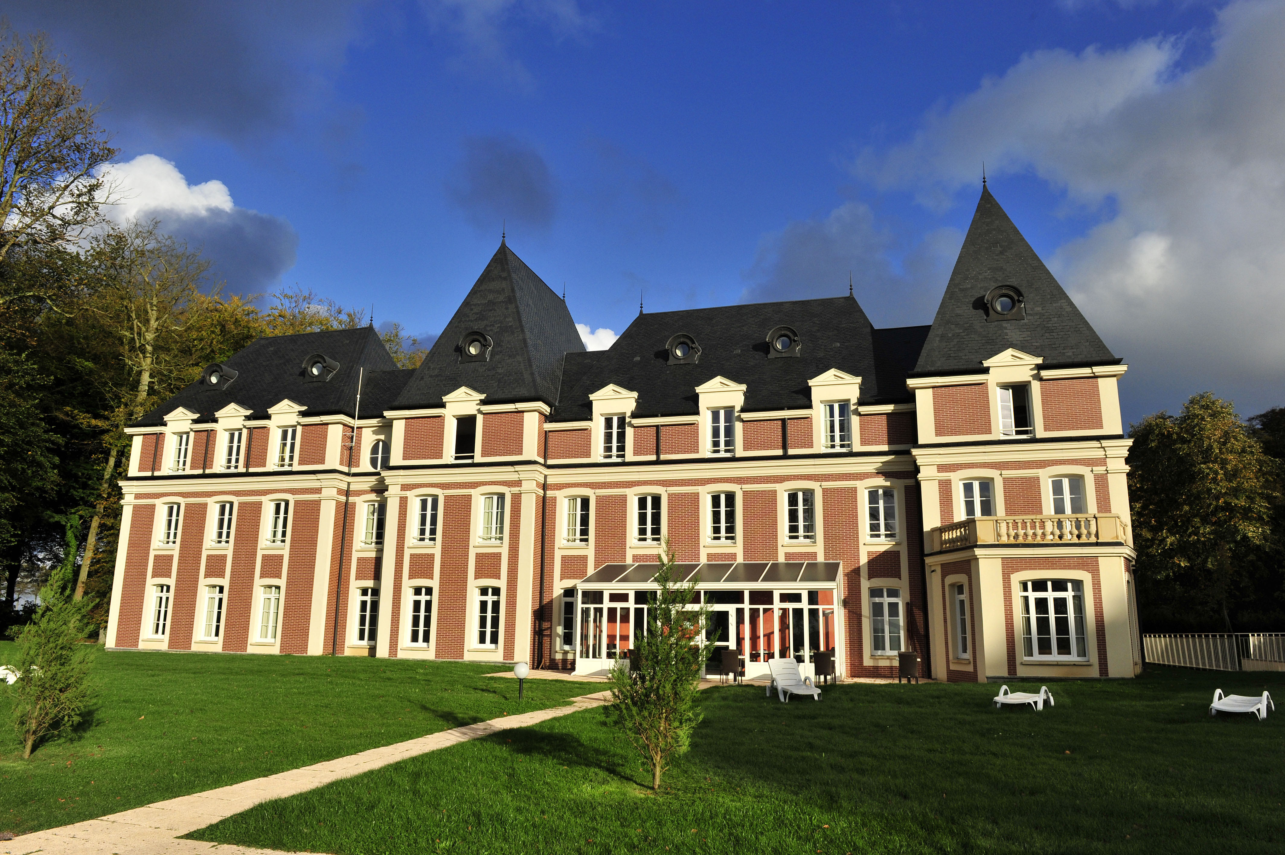 image Stone terrace seating outside the château — a quiet spot for morning coffee before the day begins