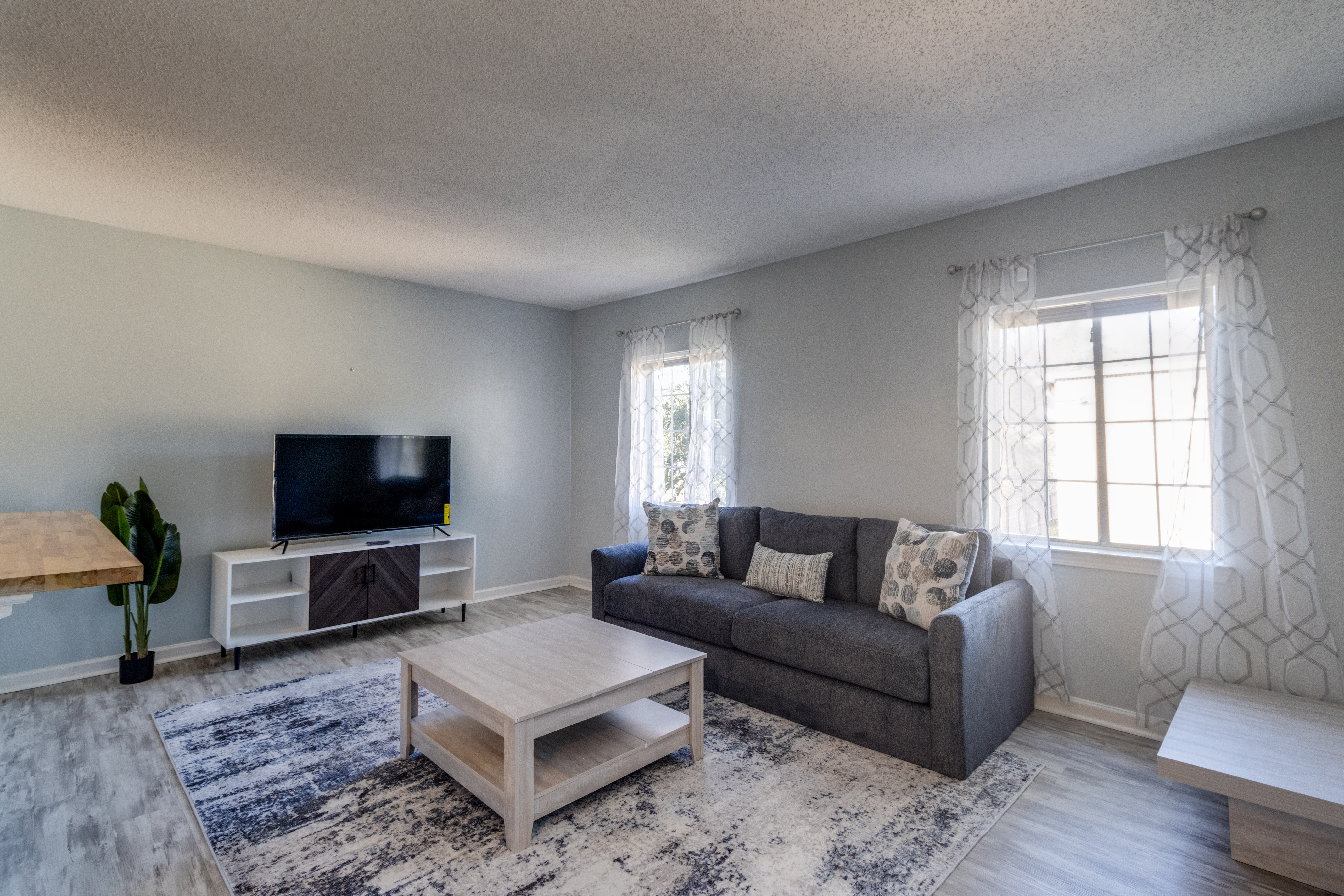 image Relax on the cozy sofa, surrounded by warm natural light and stylish decor.