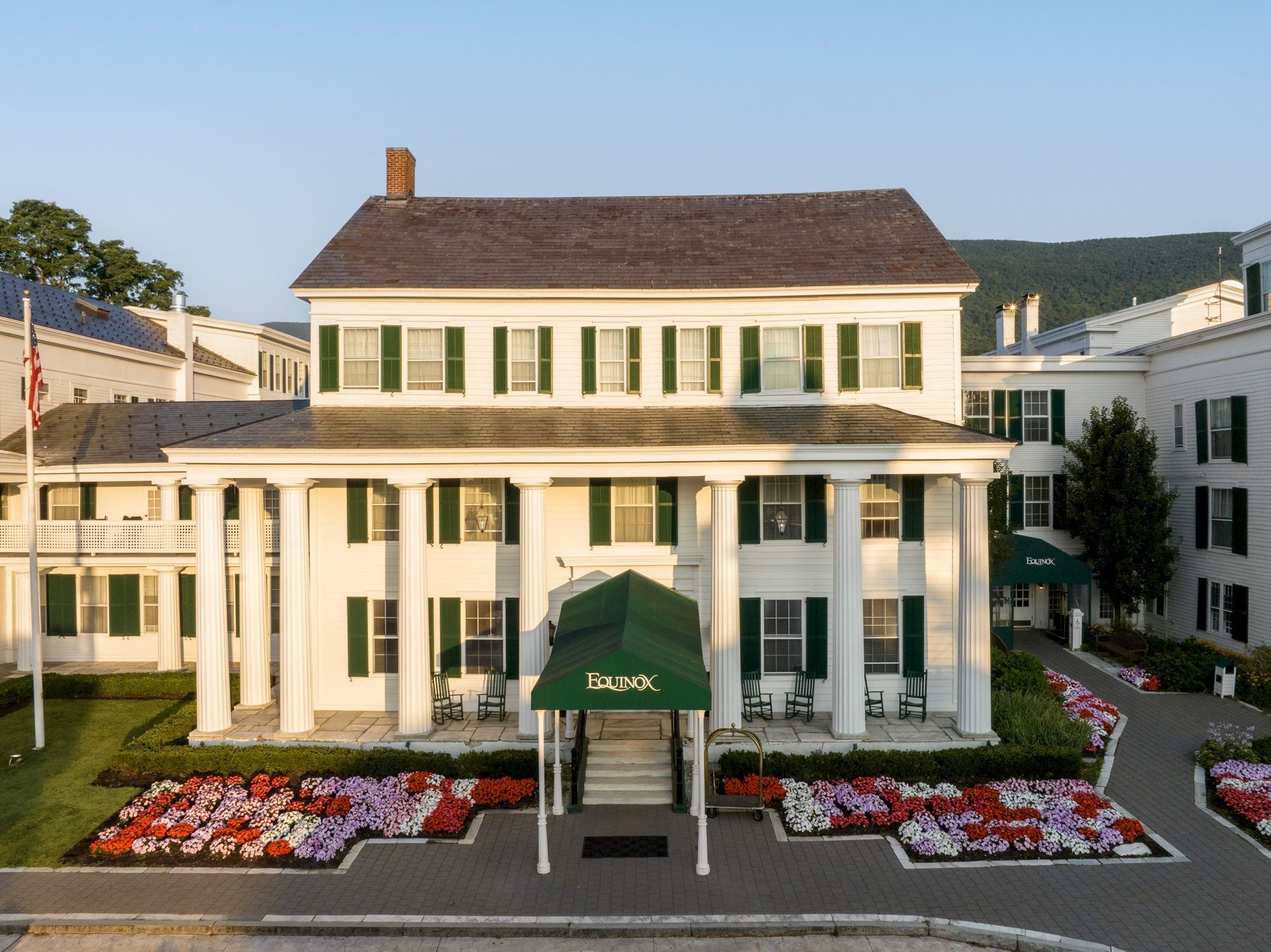 image Welcome to a charming entrance adorned with vibrant blooms and classic columns, inviting you to unwind.