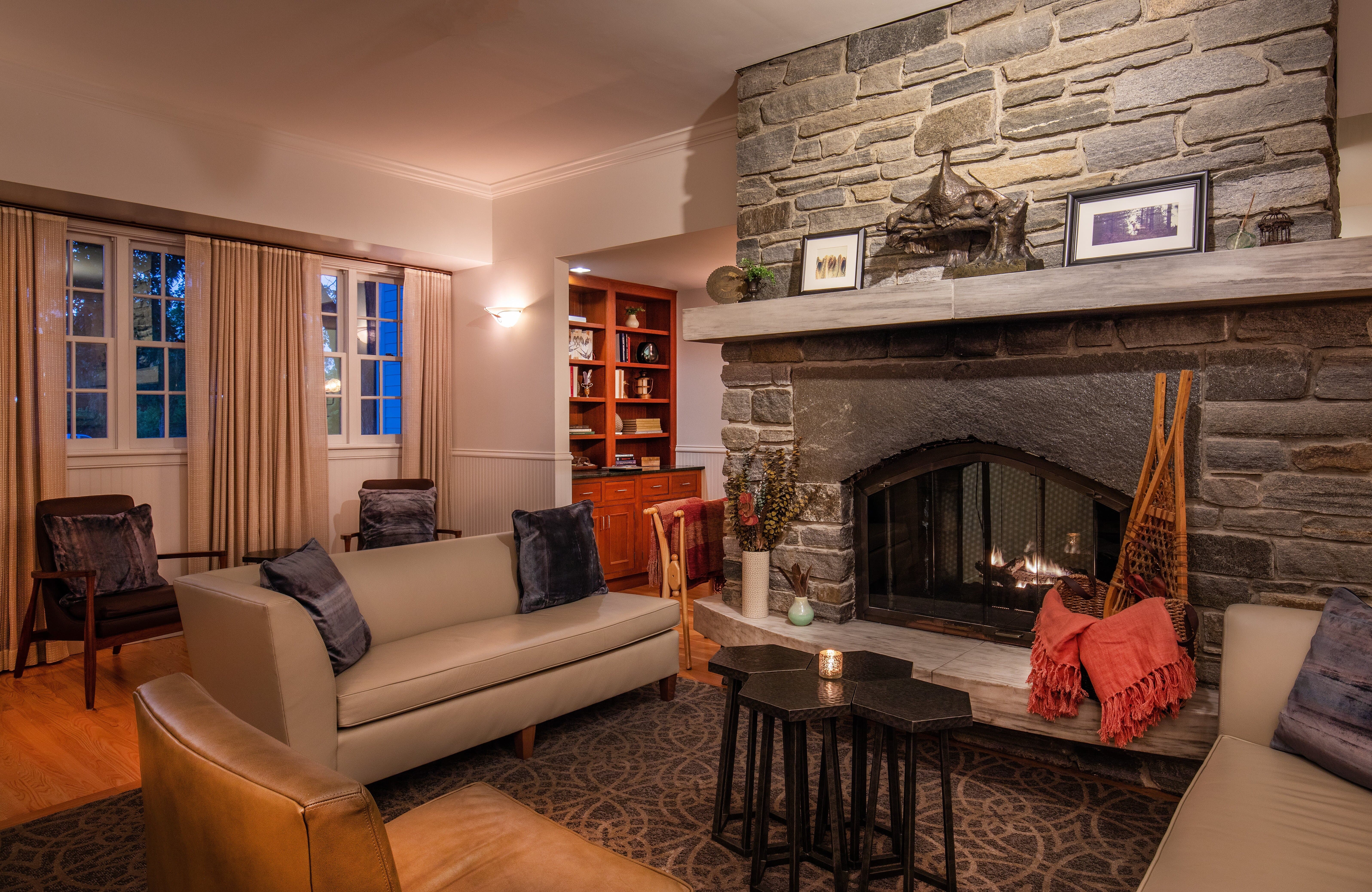 image Cozy up by the stone fireplace, where comfort meets charming decor and warm ambiance.