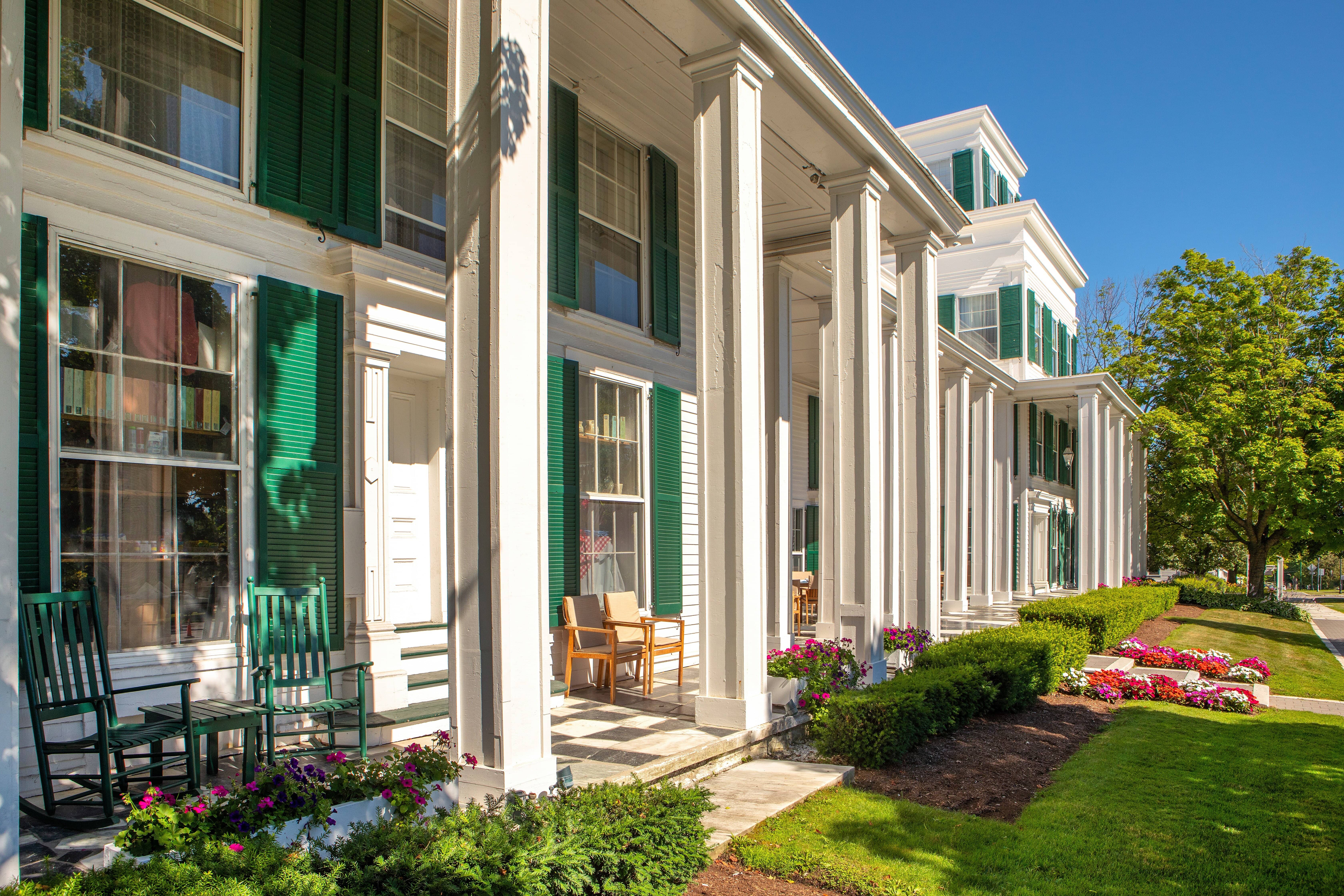 image Relax on the porch in the warm sun, surrounded by vibrant flowers and charming greenery.