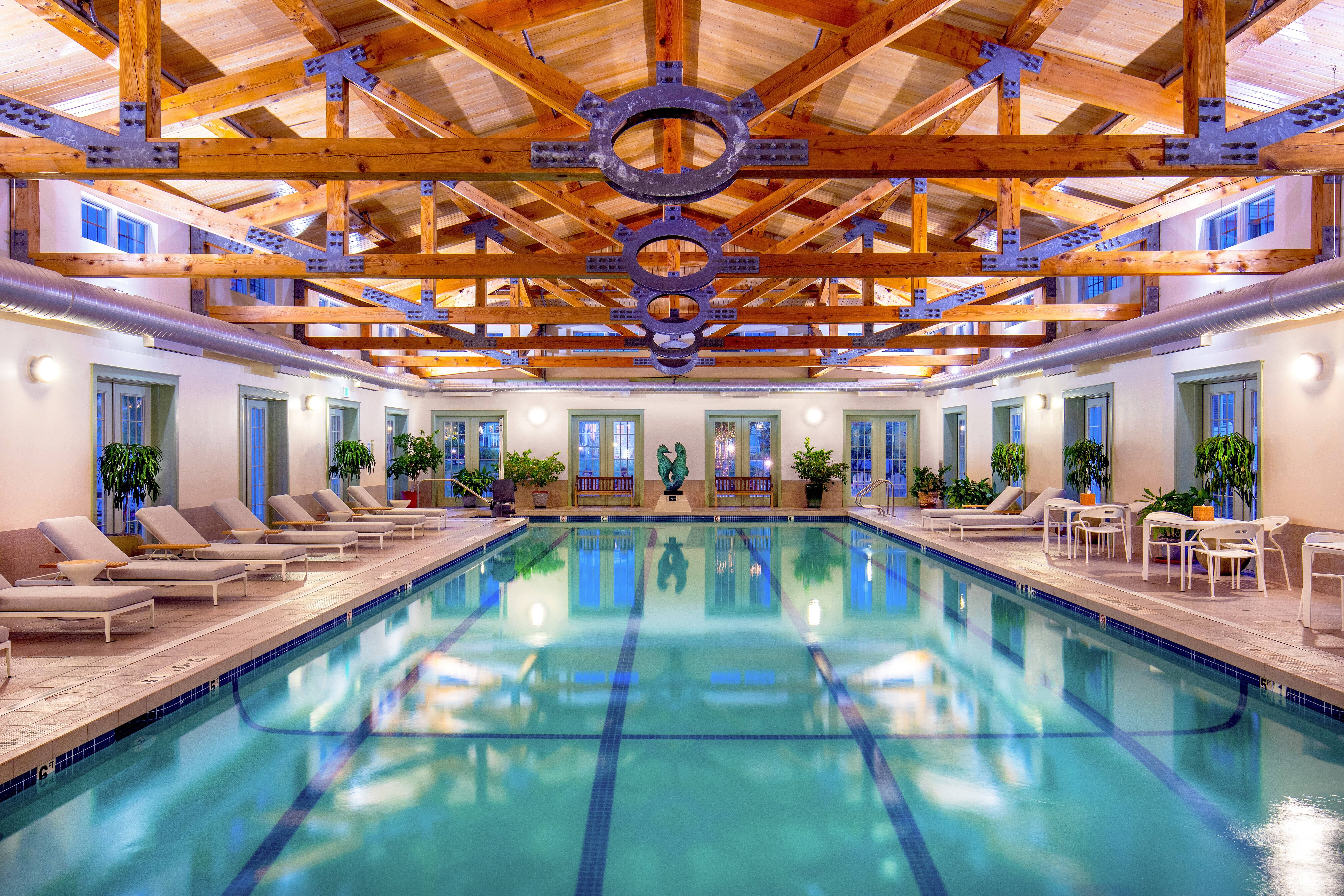 image Dive into relaxation by the shimmering pool, surrounded by elegant architecture and lush greenery.
