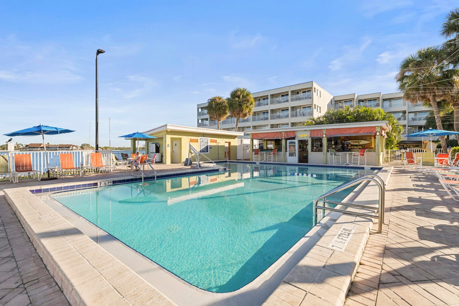 image Splash into relaxation with a refreshing swim in the pool, surrounded by inviting lounge chairs.