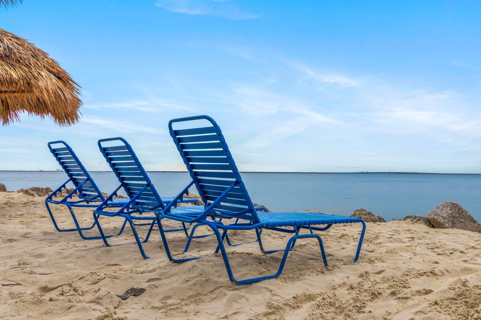 image Lounge chairs are perfectly positioned for soaking up the sun and savoring serenity by the water.
