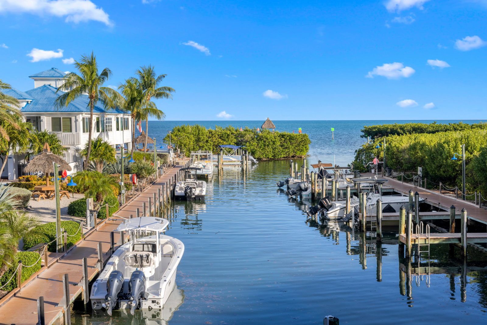 image Dock your boat and unwind at the marina, surrounded by lush greenery and gentle waves.
