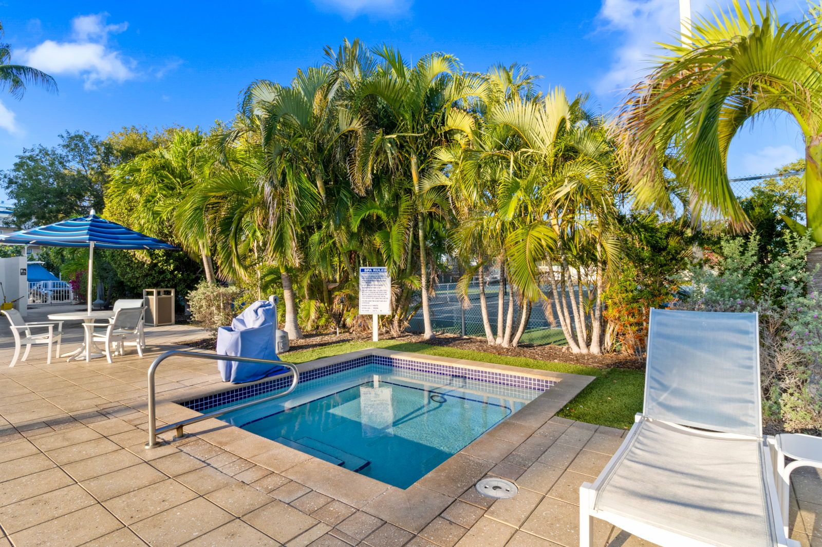 image Soak in the bubbly hot tub, nestled amidst tropical palms for the ultimate relaxation.