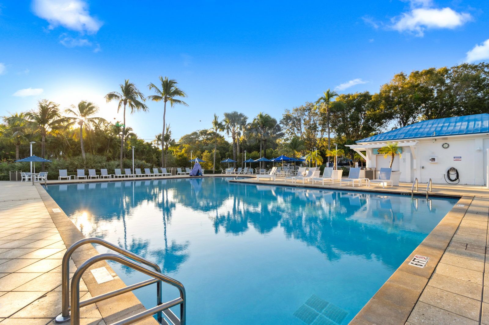 image Bask in the sun by the tranquil pool, with inviting lounge chairs dotting the deck.