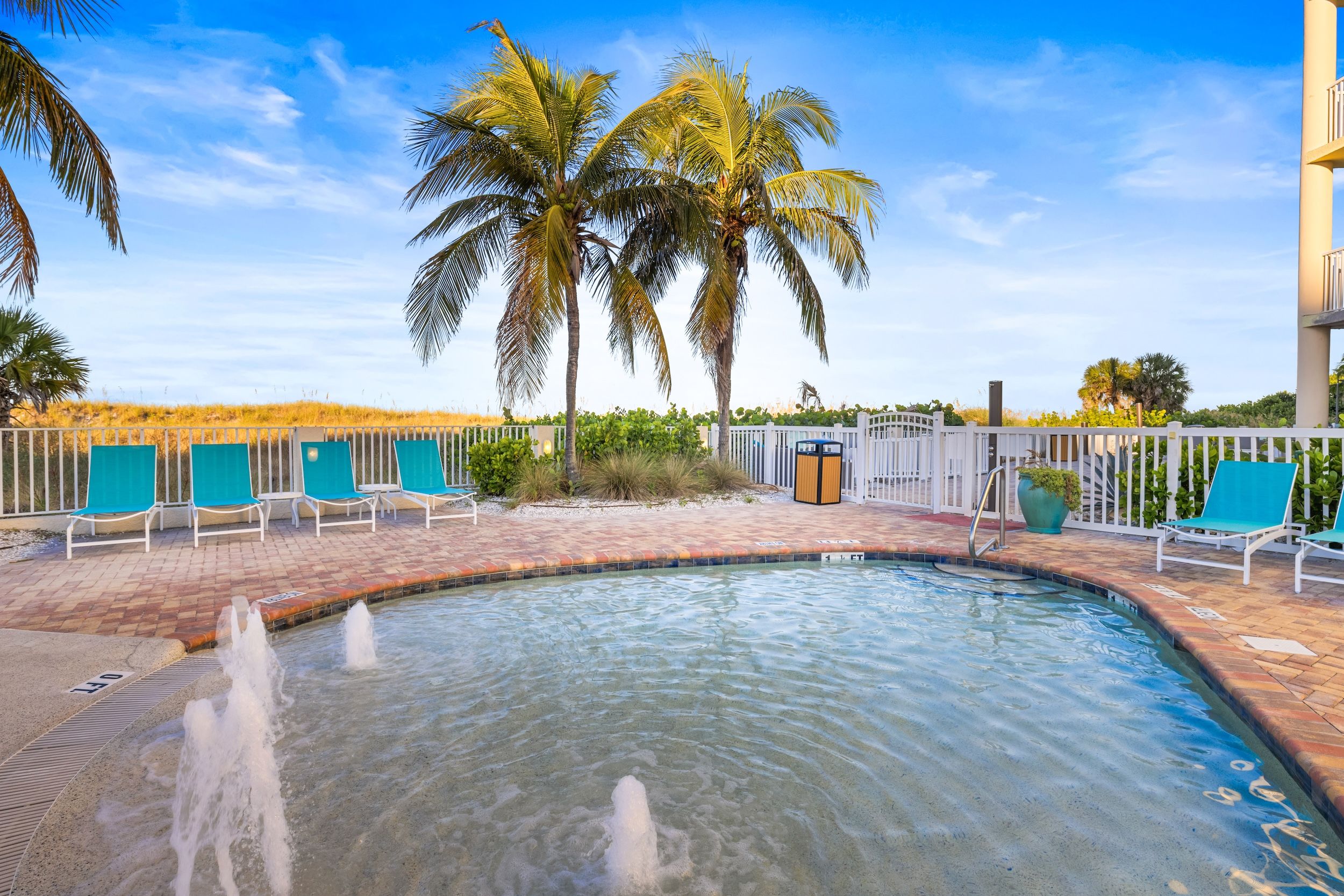 image Dive into relaxation by the poolside, surrounded by swaying palms and the sound of splashing water.