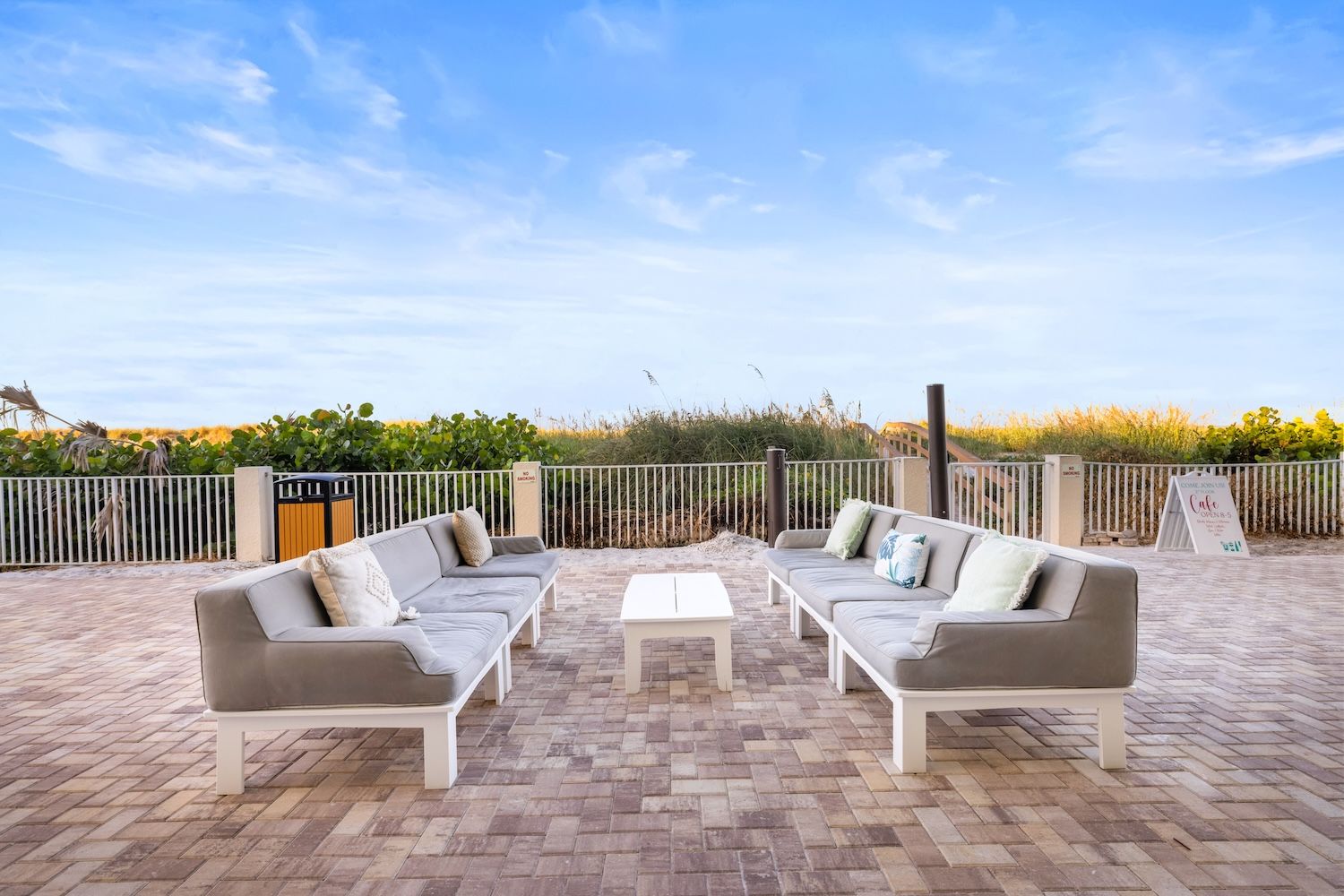 image Gather with friends on spacious couches, perfect for unwinding with a drink after a day at the beach.