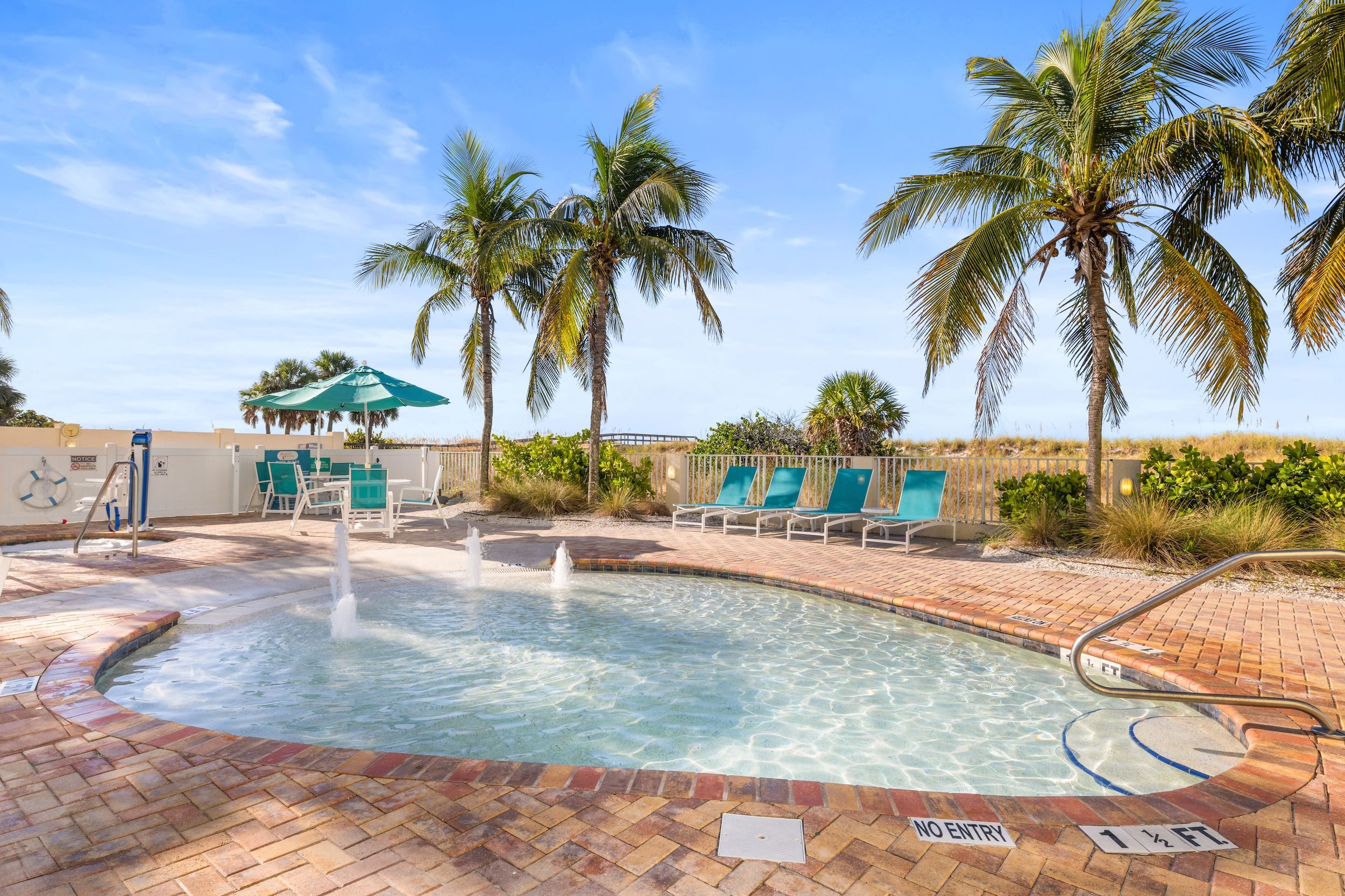 image Soak in the sun, just steps from the beach and nestled among tropical landscaping.
