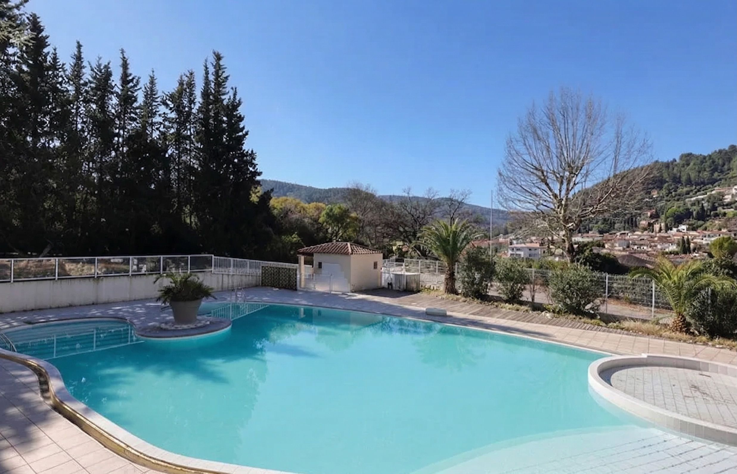 image Take a dip in the inviting pool while enjoying the sun and greenery of the surrounding hills.