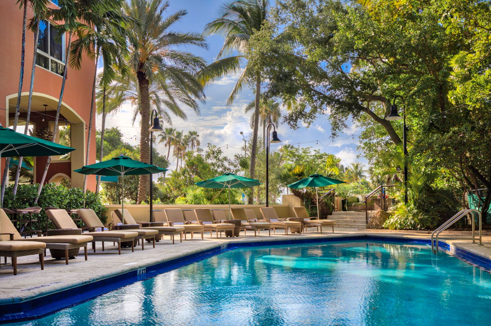image Bask in the sun on comfortable loungers, under the inviting shade of umbrellas.