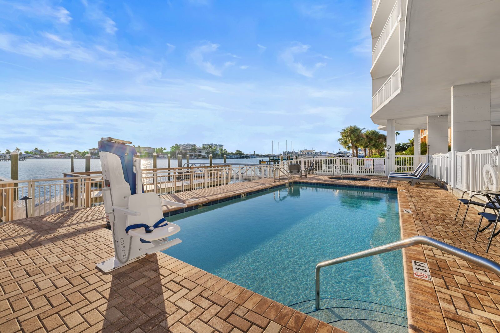 image Take a refreshing dip in the inviting pool, perfectly set against the serene bay backdrop.