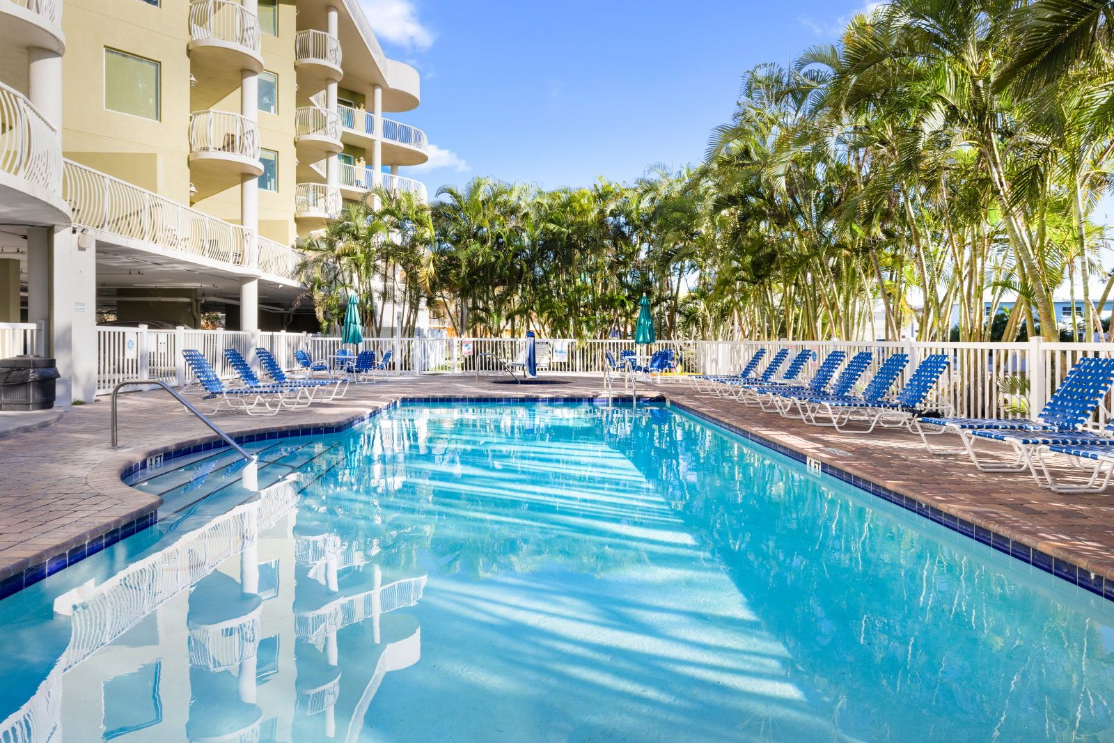 image Dive into refreshing waters, with inviting loungers patiently waiting for you.