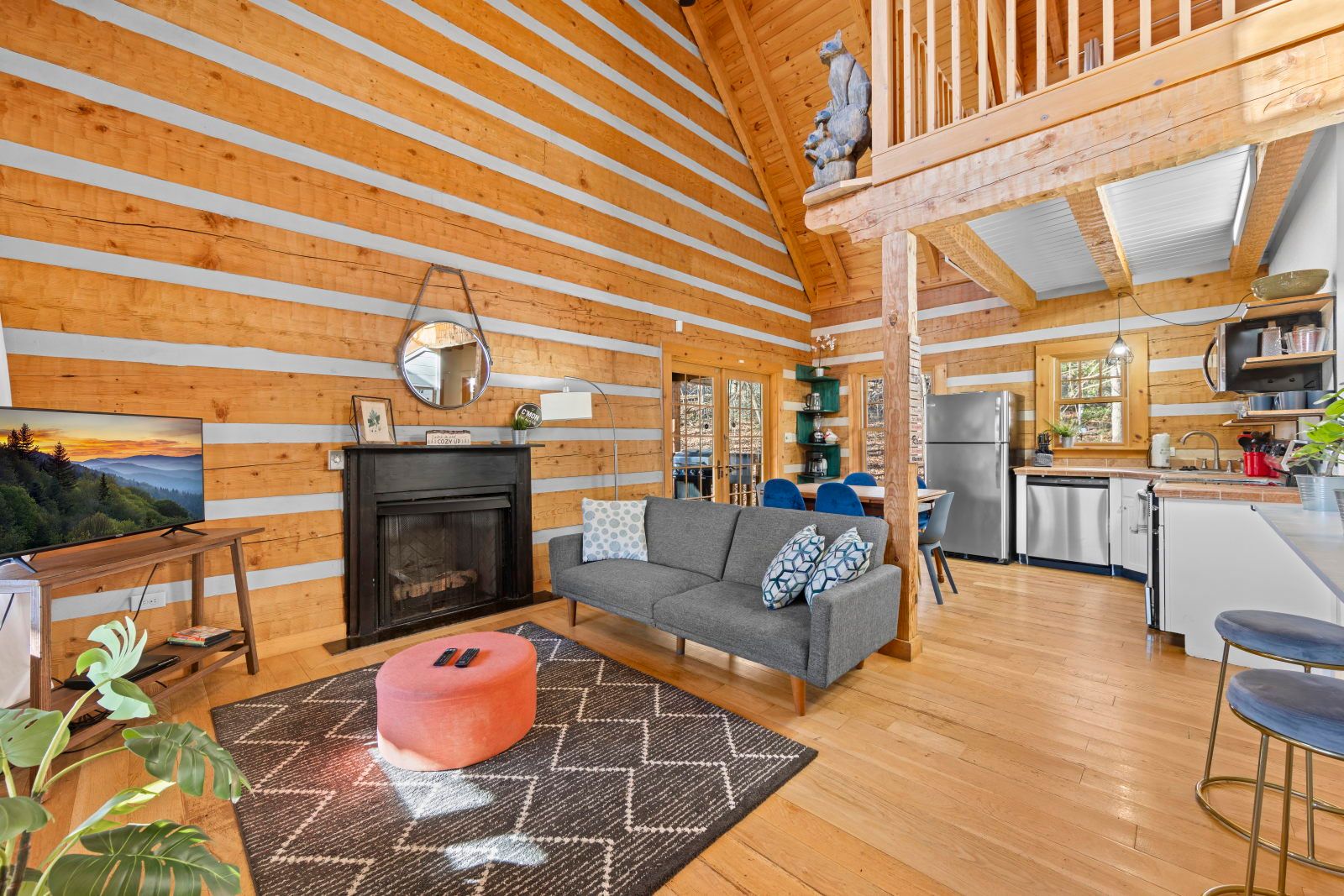 image Gather around the cozy living space, with a warm fireplace and inviting decor for a perfect evening in.