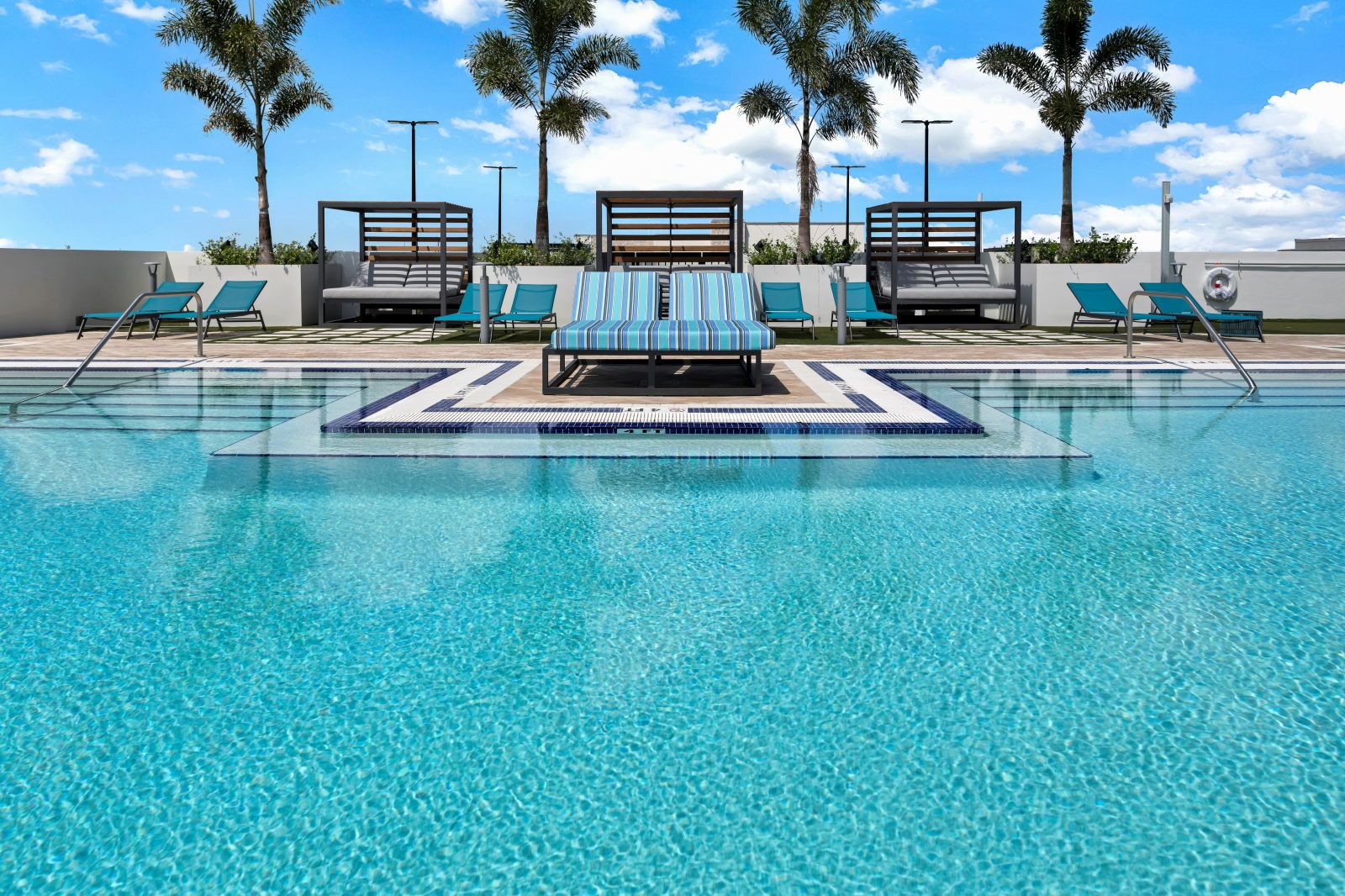 image Unwind in a vibrant atmosphere where comfort meets style, near inviting cabanas and crystal-clear waters.