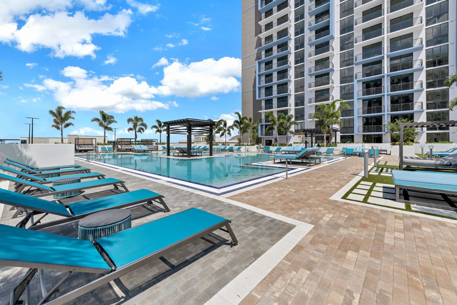 image Enjoy a tranquil pool day with plush seating and a beautifully landscaped area waiting for you.