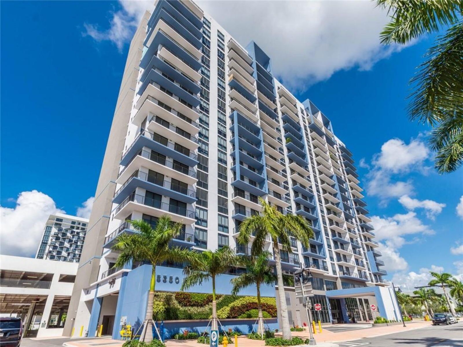 image Admire the modern architecture framed by clear blue skies and swaying palm trees.