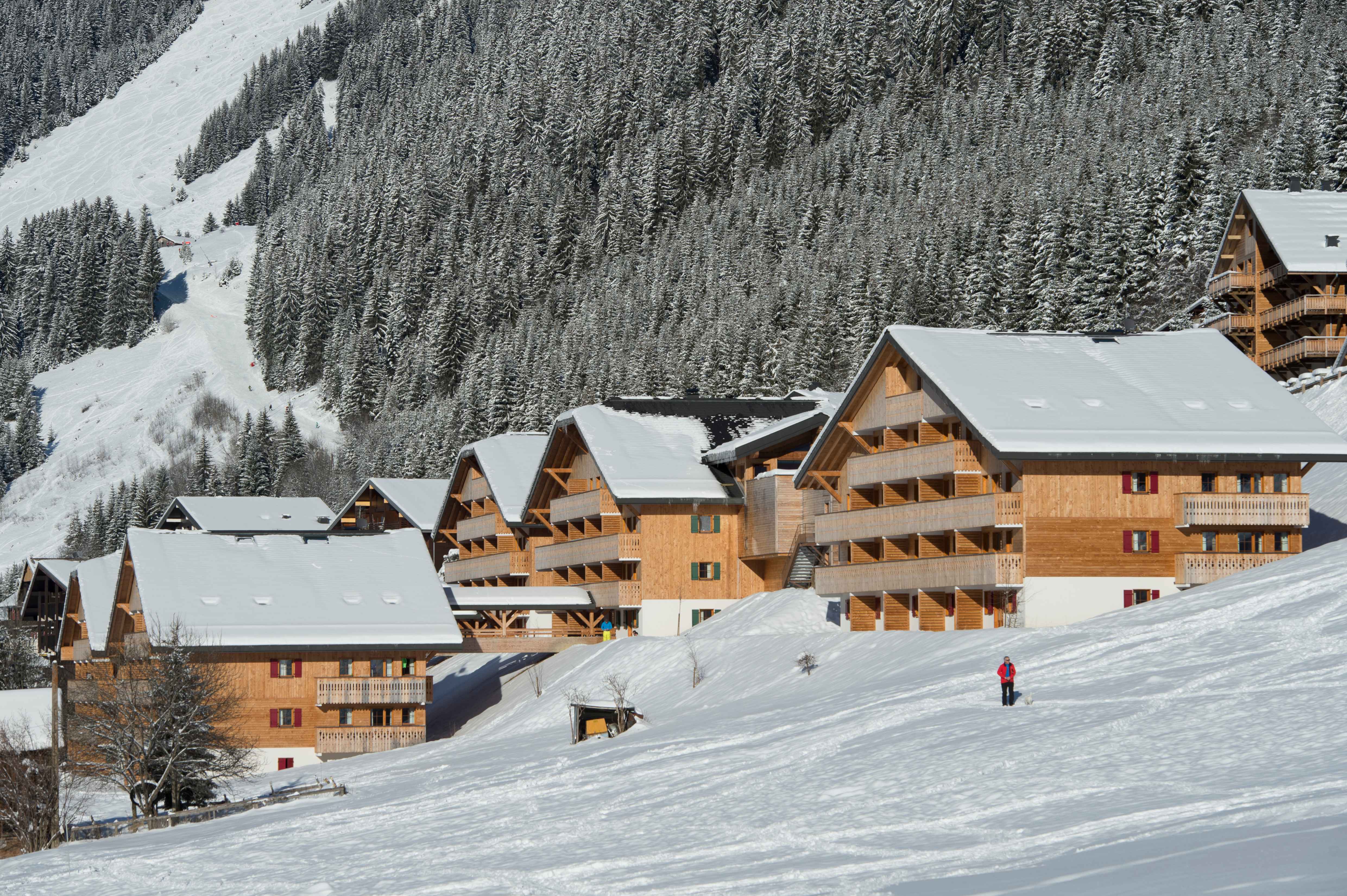 image Le Grand Lodge in winter — five traditional Savoyard chalets blanketed in snow, just 800 m from the Châtel ski lifts.
