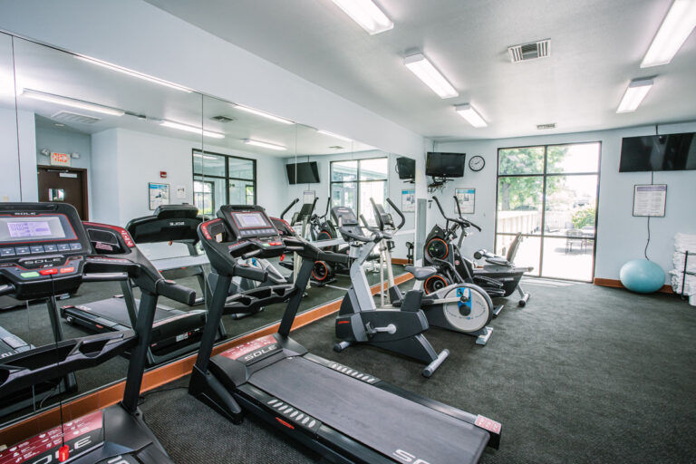 image Fitness room with treadmills, ellipticals, wall-mounted TVs, and mirrored walls — open during your stay.