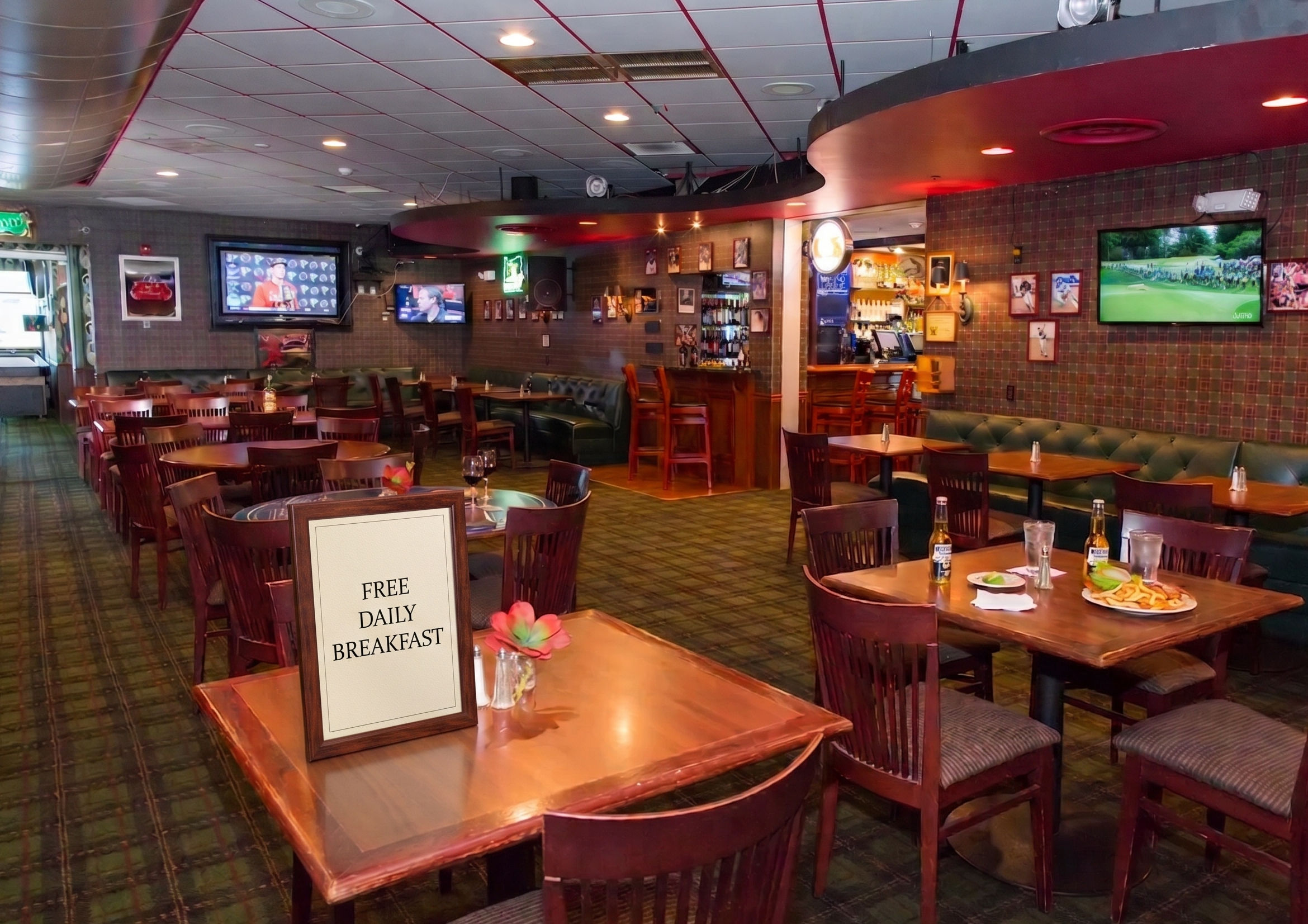 image Chadwick's Pub & Grill interior with booth seating and multiple TV screens — live comedy runs Friday and Saturday nights.