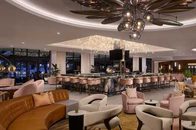 The resort bar glows at night — settle in for a post-round drink with the rest of the day behind you