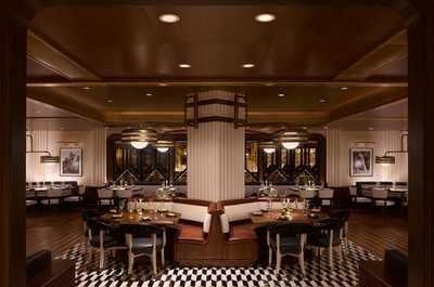 Dinner with white tablecloths, warm lighting, and a menu built for a leisurely evening