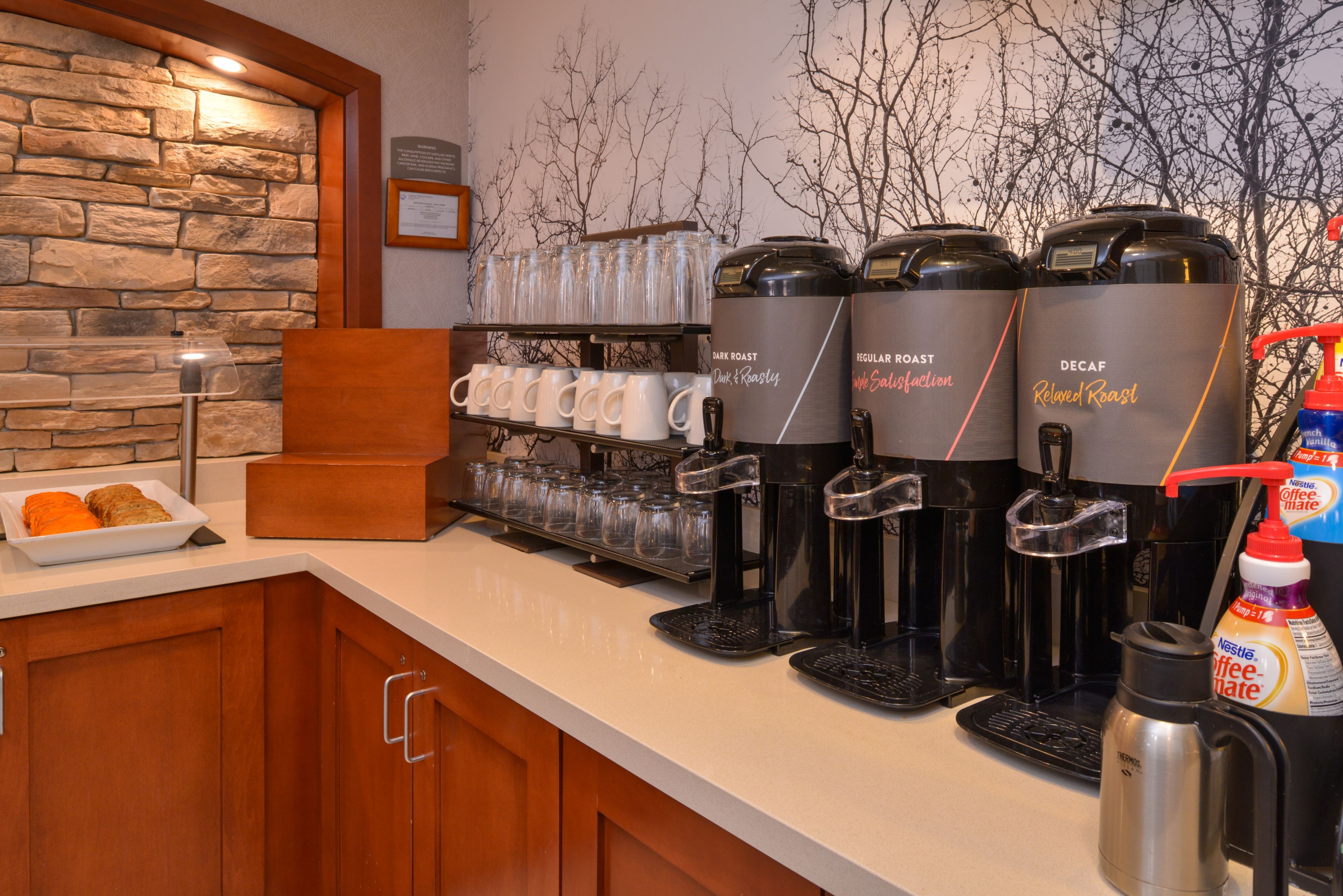 image Breakfast station with a selection of beverages and treats.
