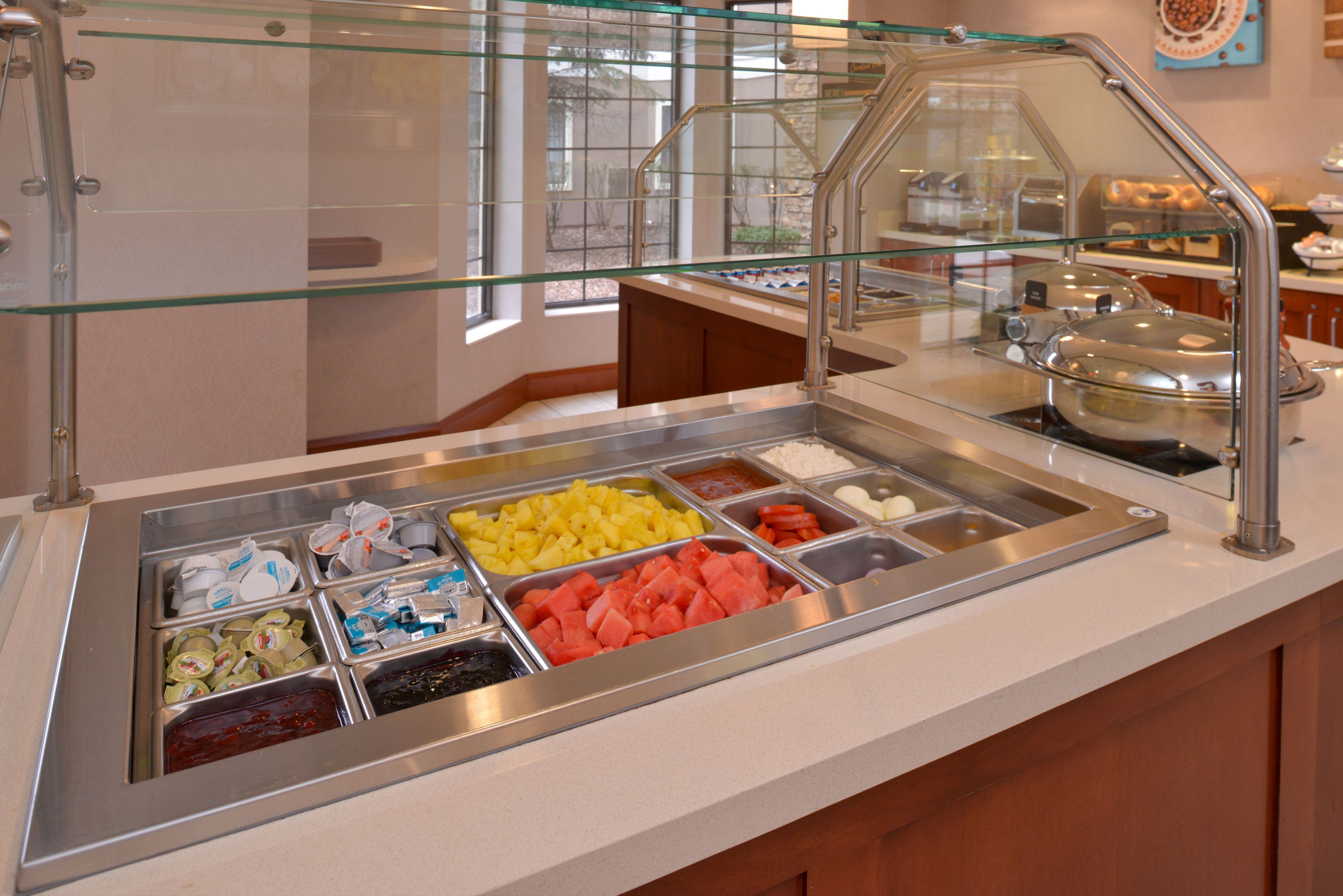 image Breakfast bar displaying fresh fruits and condiments.
