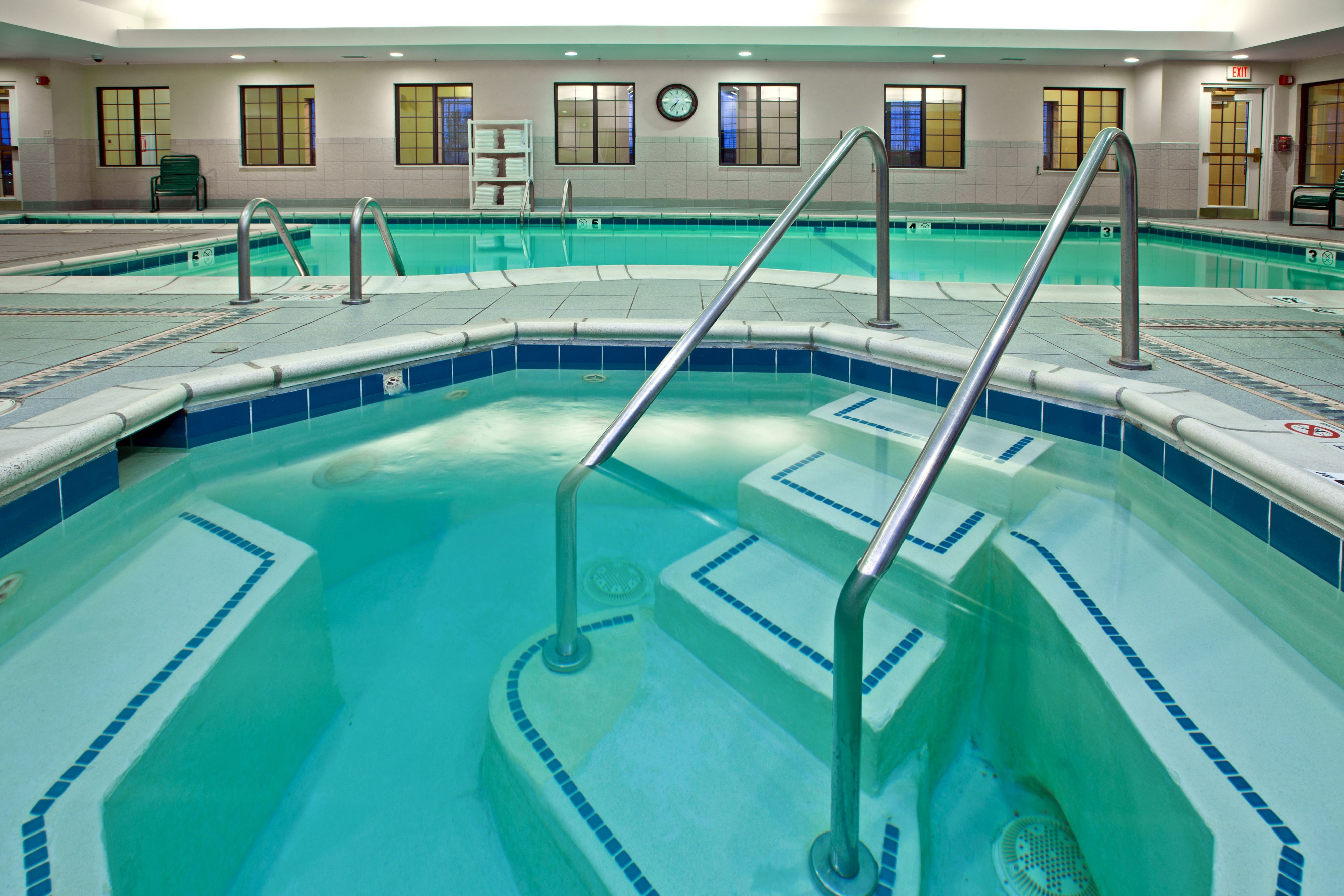 image Indoor hot tub with entry steps and handrails on deck.