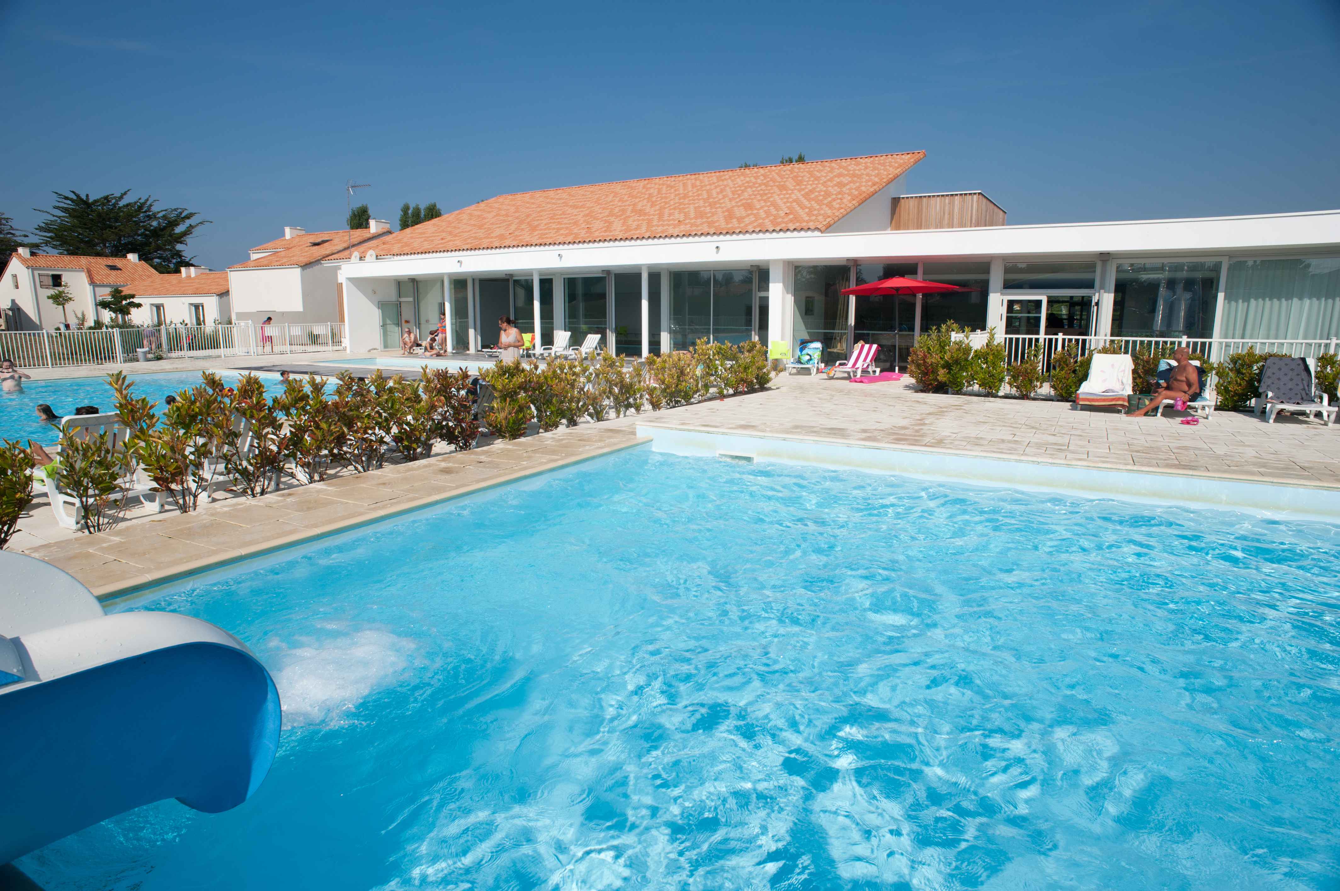 image The outdoor pool with its water slide is the heart of the residence during the summer season.