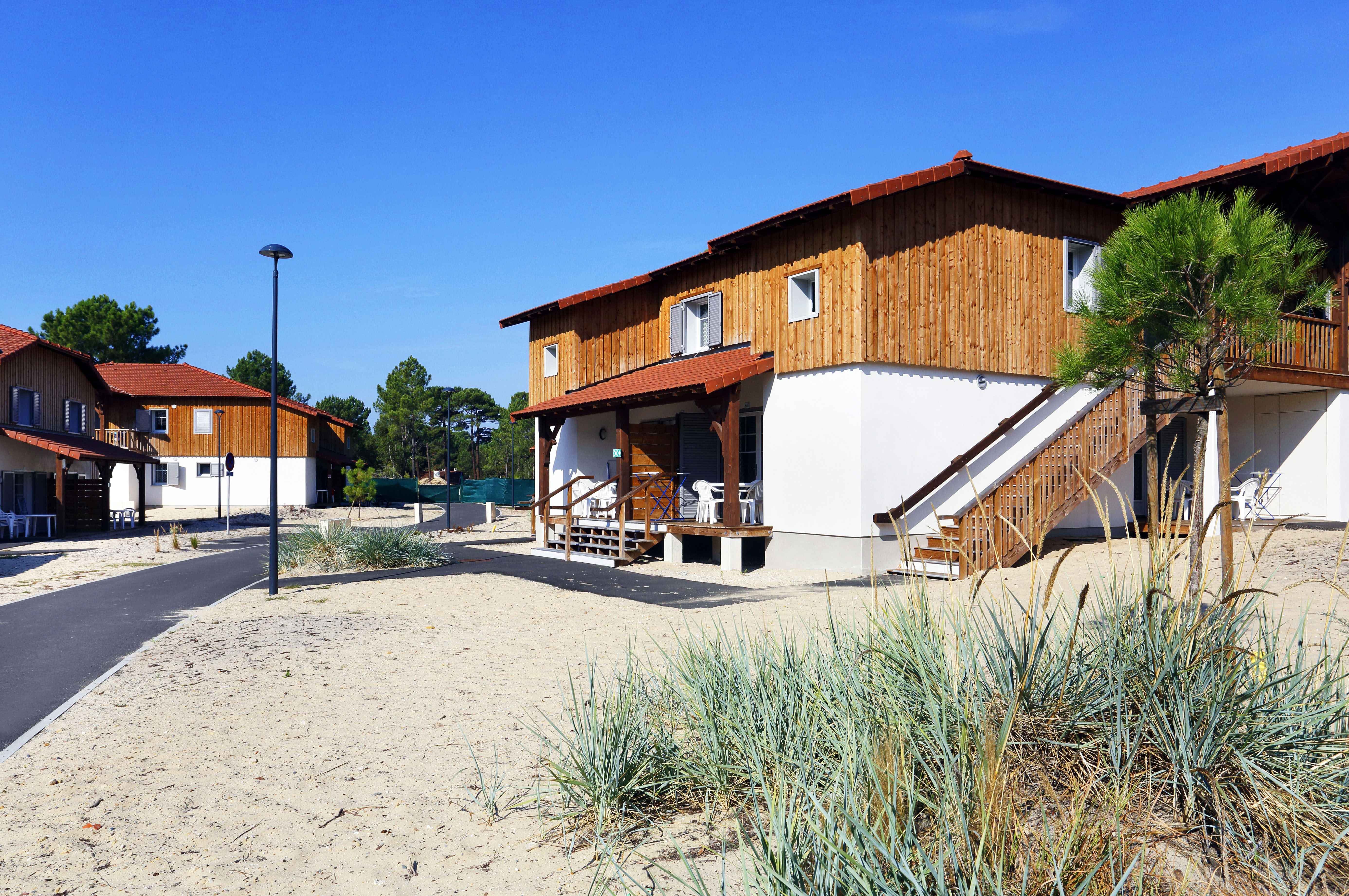 image Grassy open spaces between the houses give kids room to run while you take in the pine-scented air.
