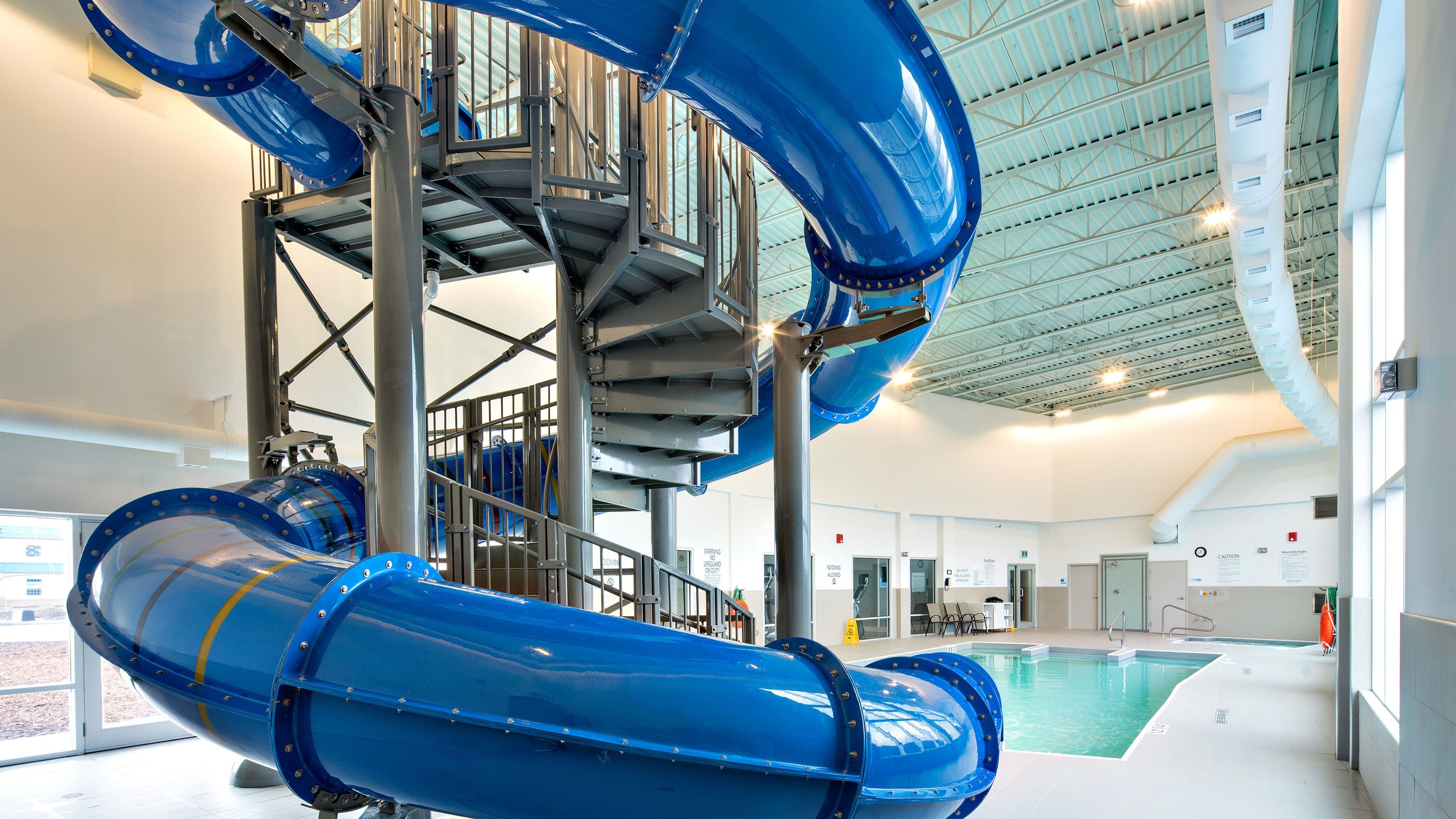 image Blue water slide above the indoor pool area.